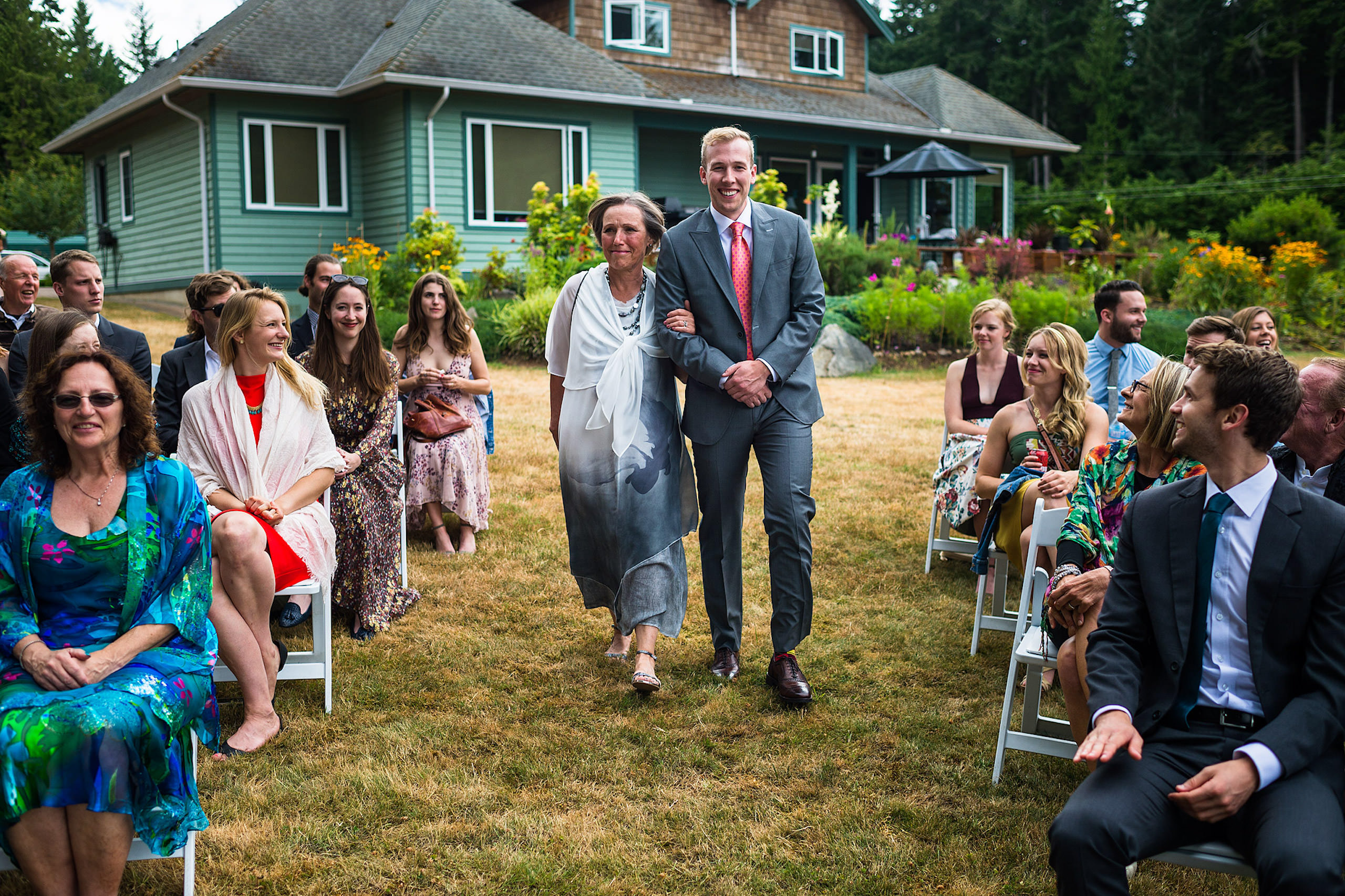 A groom walking his mom down the aisle at a backyard wedding in BC - Qualicum Wedding Photographer