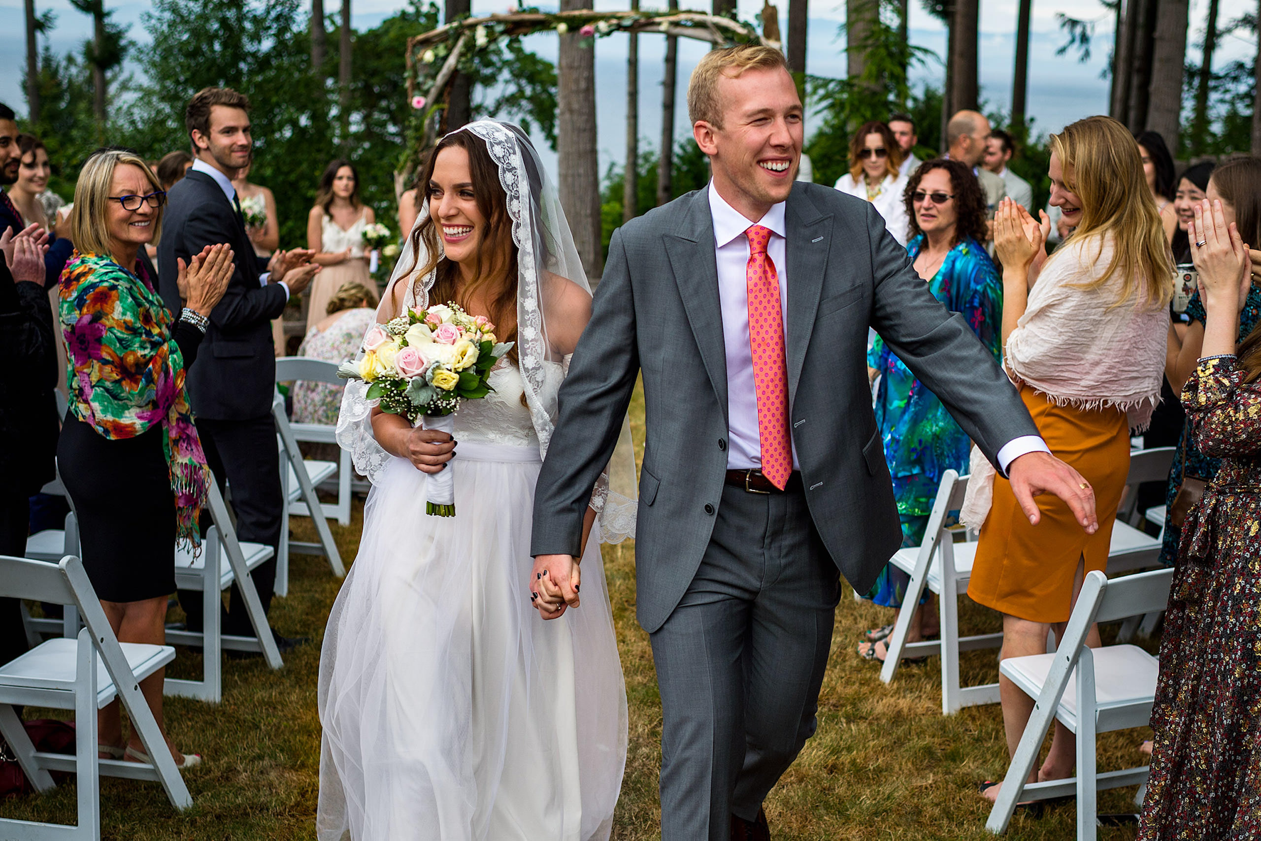 A bride and groom walking down the aisle as a married couple - Qualicum Wedding Photographer