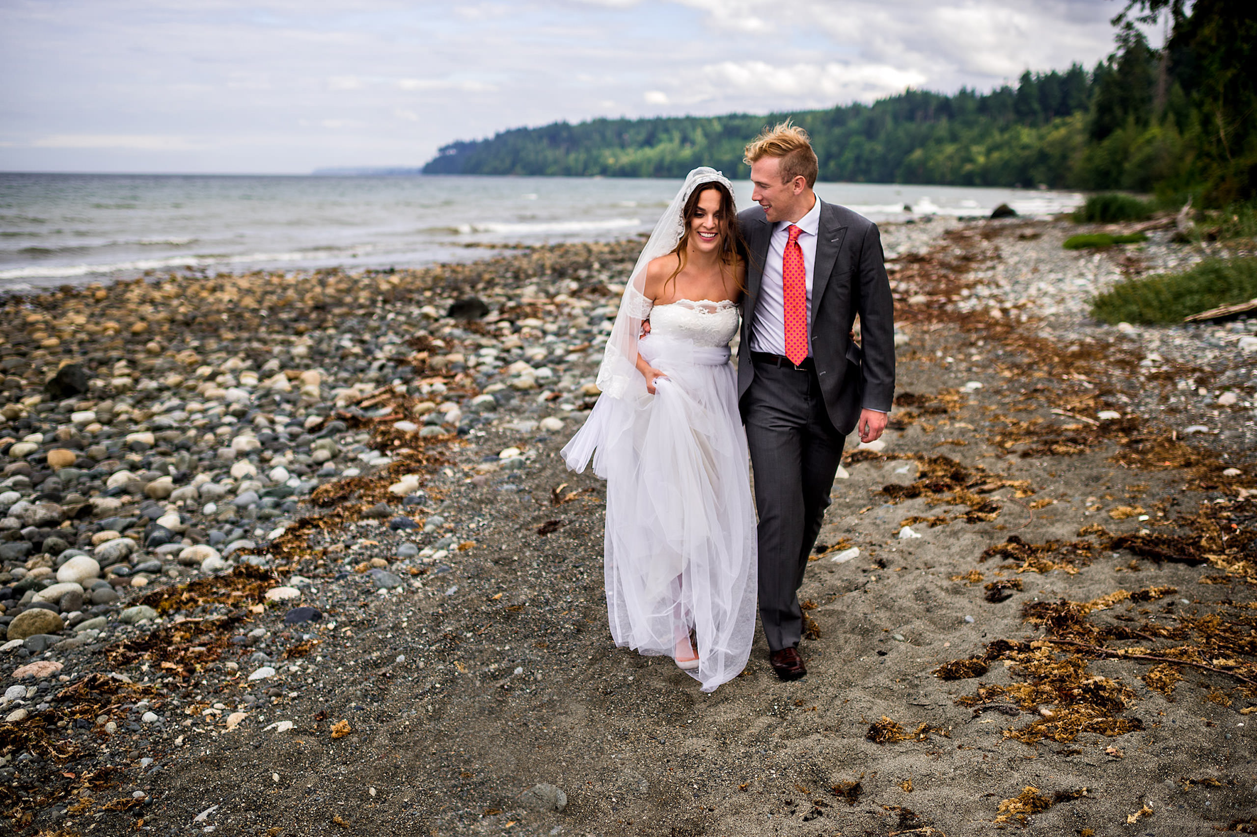 A bride and groom walking down a beach in BC - Qualicum Wedding Photographer