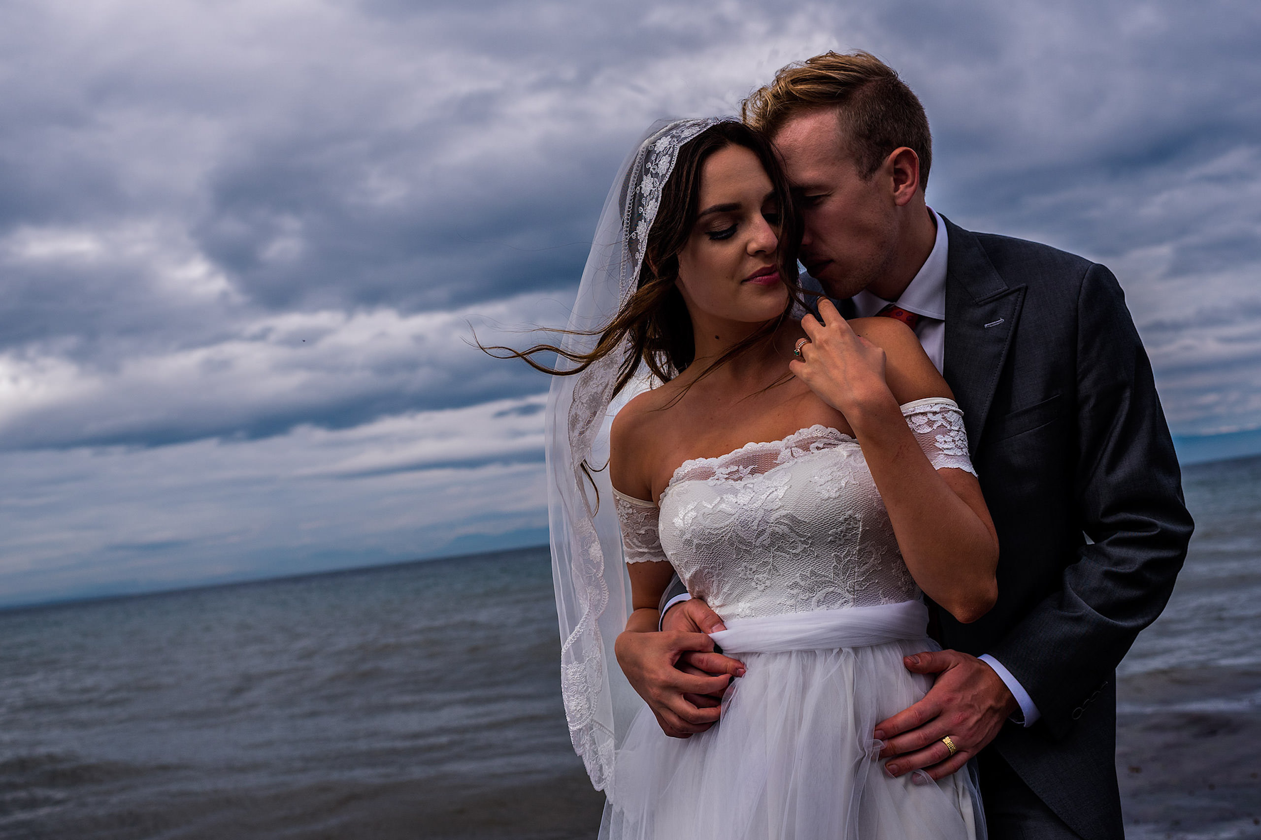 A close up of a bride and groom in a portrait infront of the ocean - Qualicum Wedding Photographer