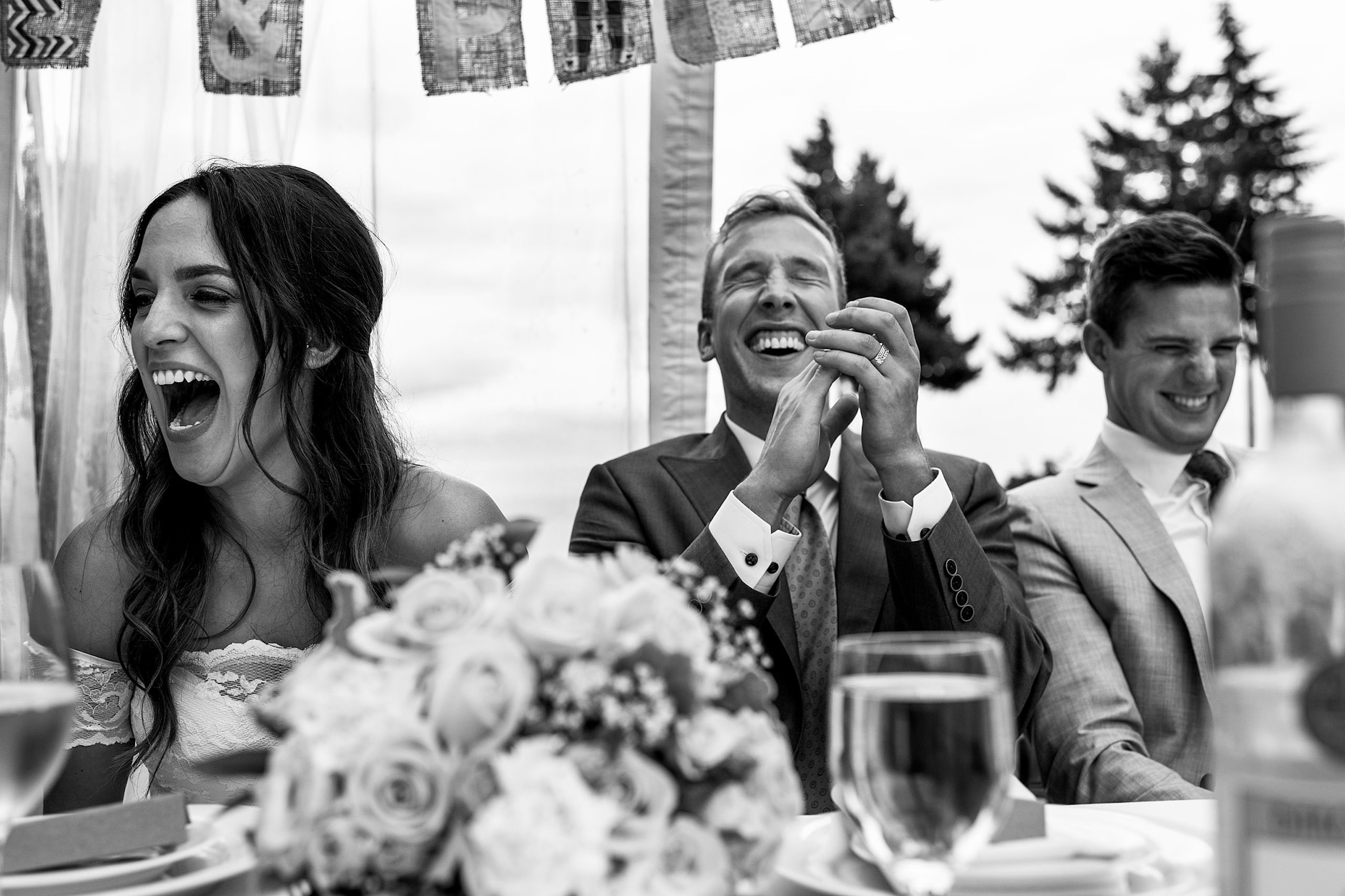 A groom laughing at the best mans speech in BC - Qualicum Wedding Photographer