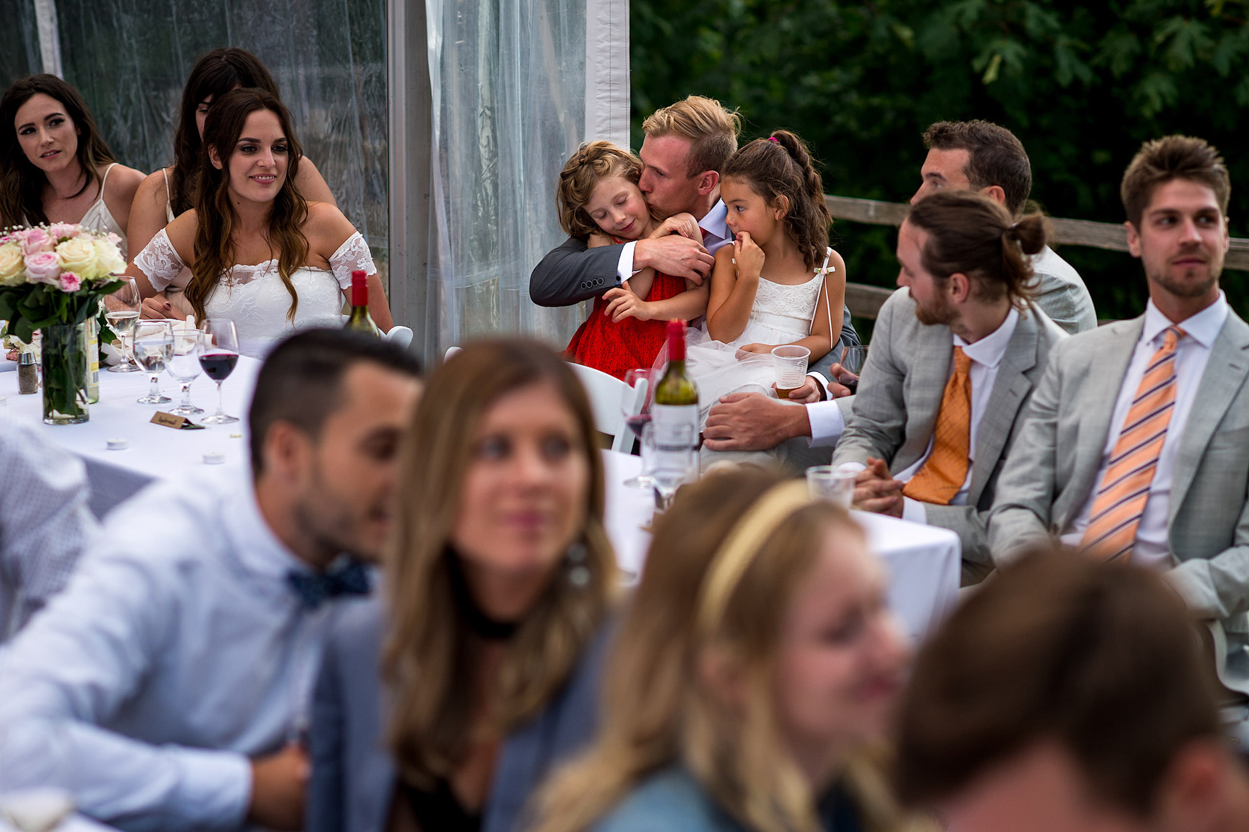 A groom kissing his niece at his wedding reception - Qualicum Wedding Photographer