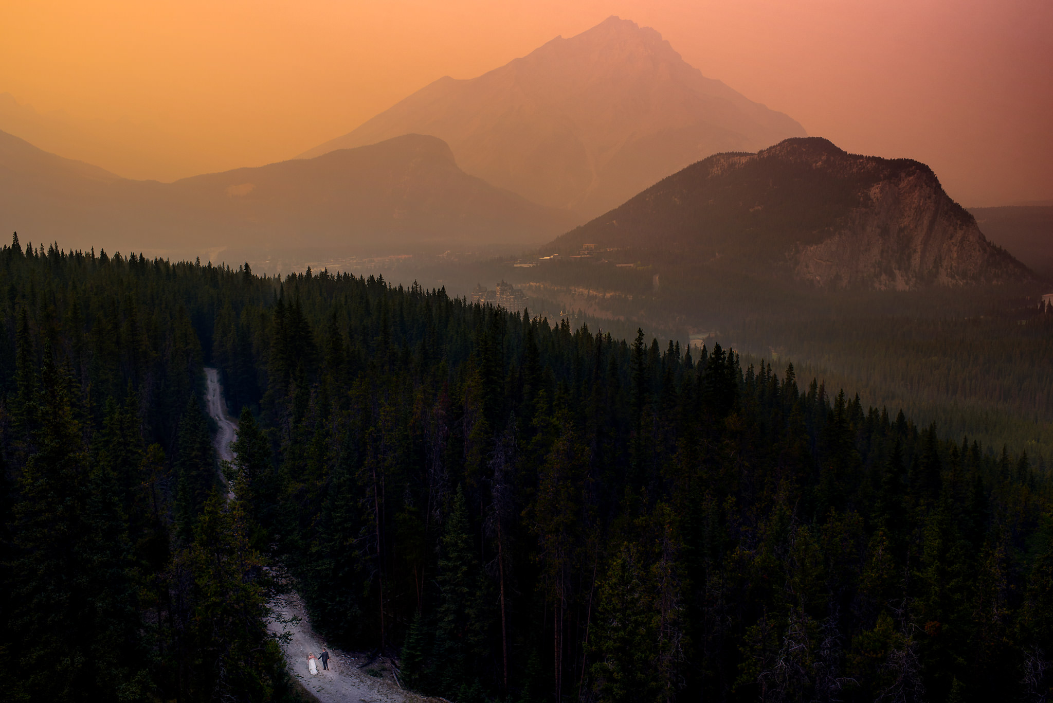 bride and groom walking in the mountains by Banff wedding photographer