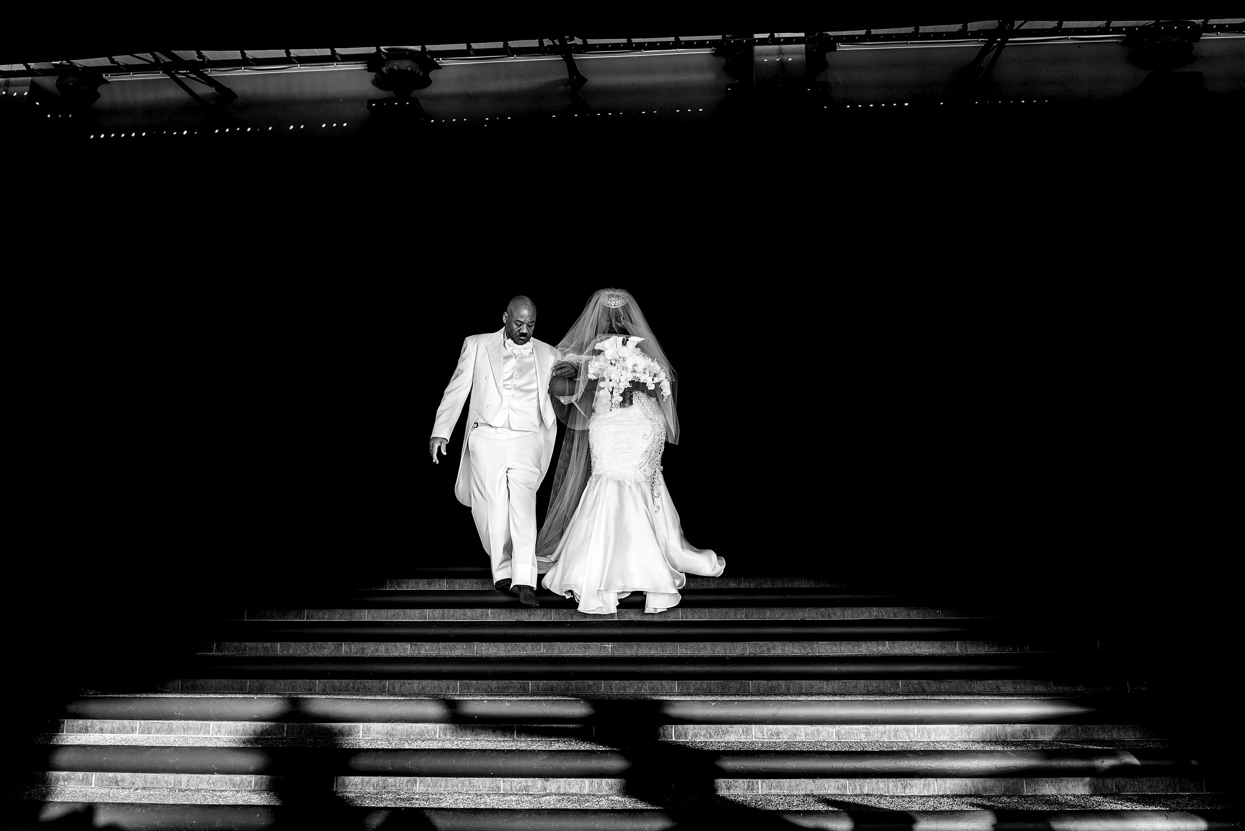 bride walking with her dad to her wedding reception by destination wedding photographer