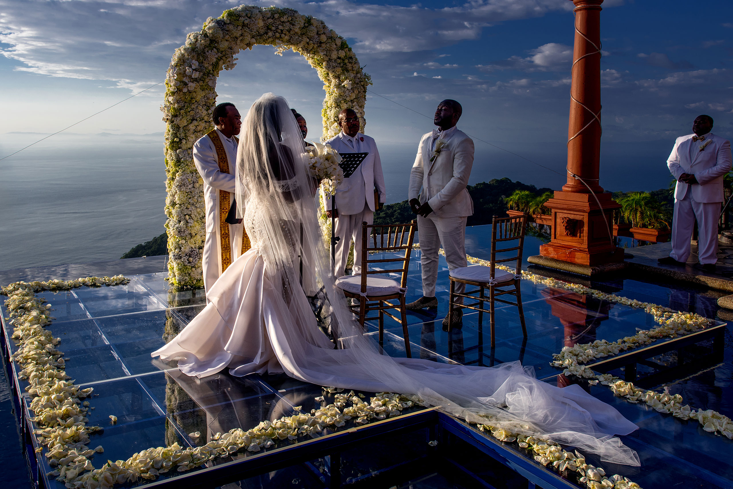 a bride with a long dress looking at groom in front of the ocean at Zephyr Palace Destination Wedding in Costa Rica by Sean LeBlanc