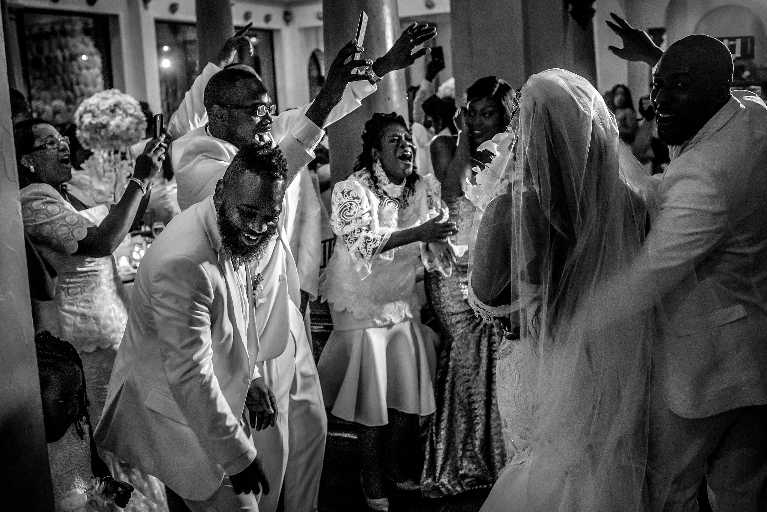 guests celebrating as a bride and groom enter the reception at Zephyr Palace Destination Wedding in Costa Rica by Sean LeBlanc