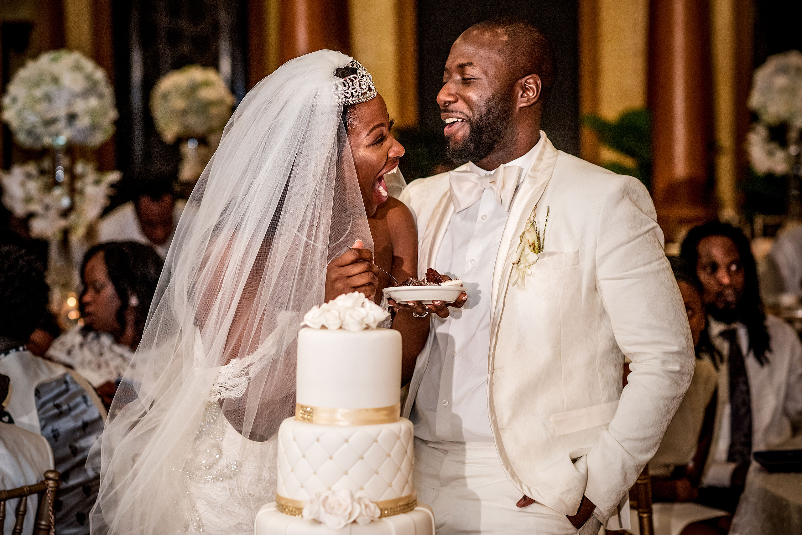 bride and groom laughing while eating cake at Costa Rica wedding