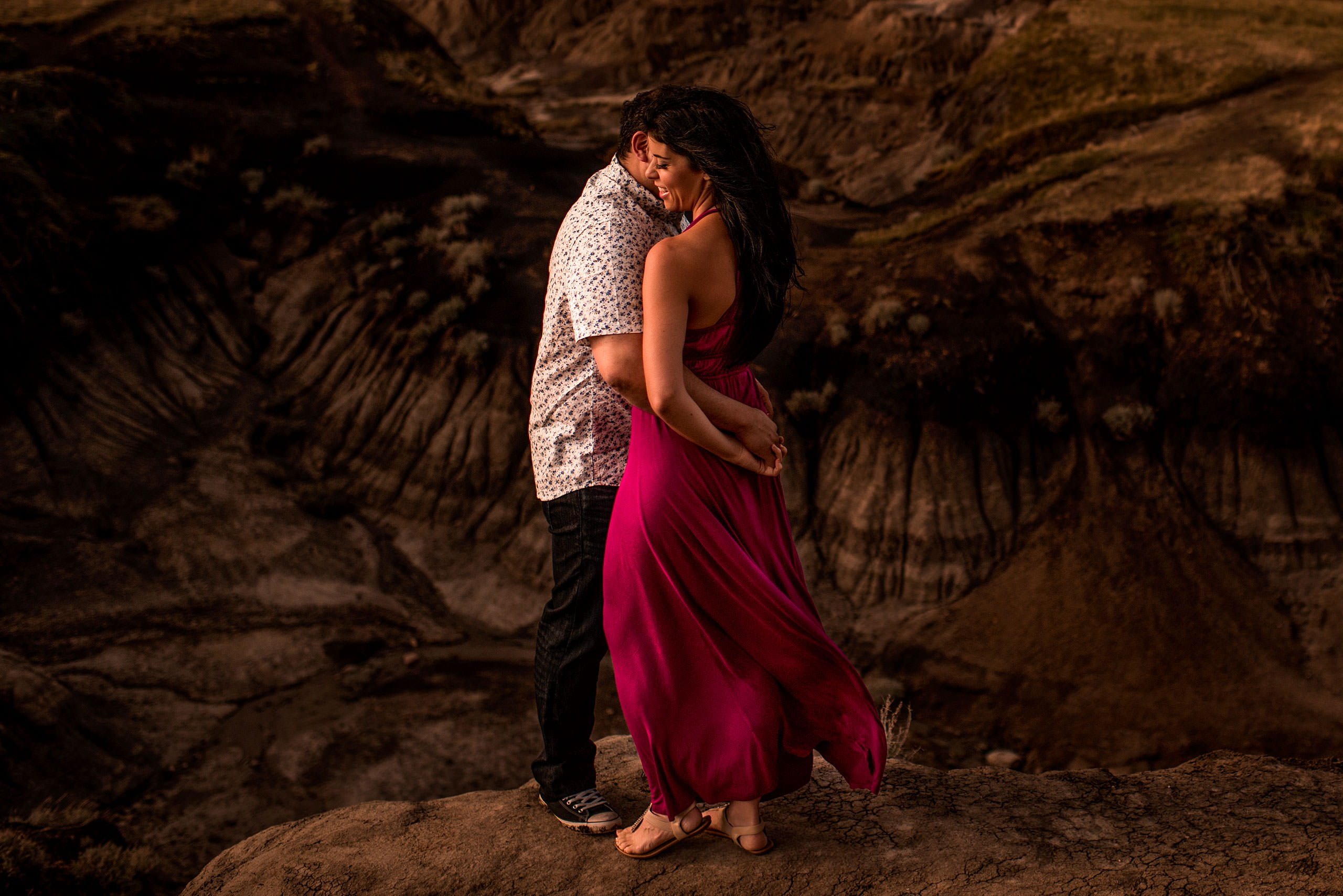 girl wearing a purple dress holding her fiancé in a canyon - calgary sean leblanc wedding photographers
