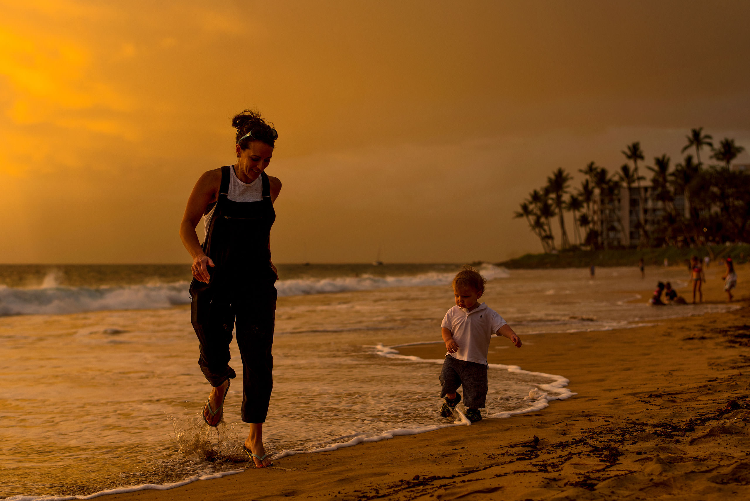 a mom and her son running on the beach by destination family photographers sean leblanc