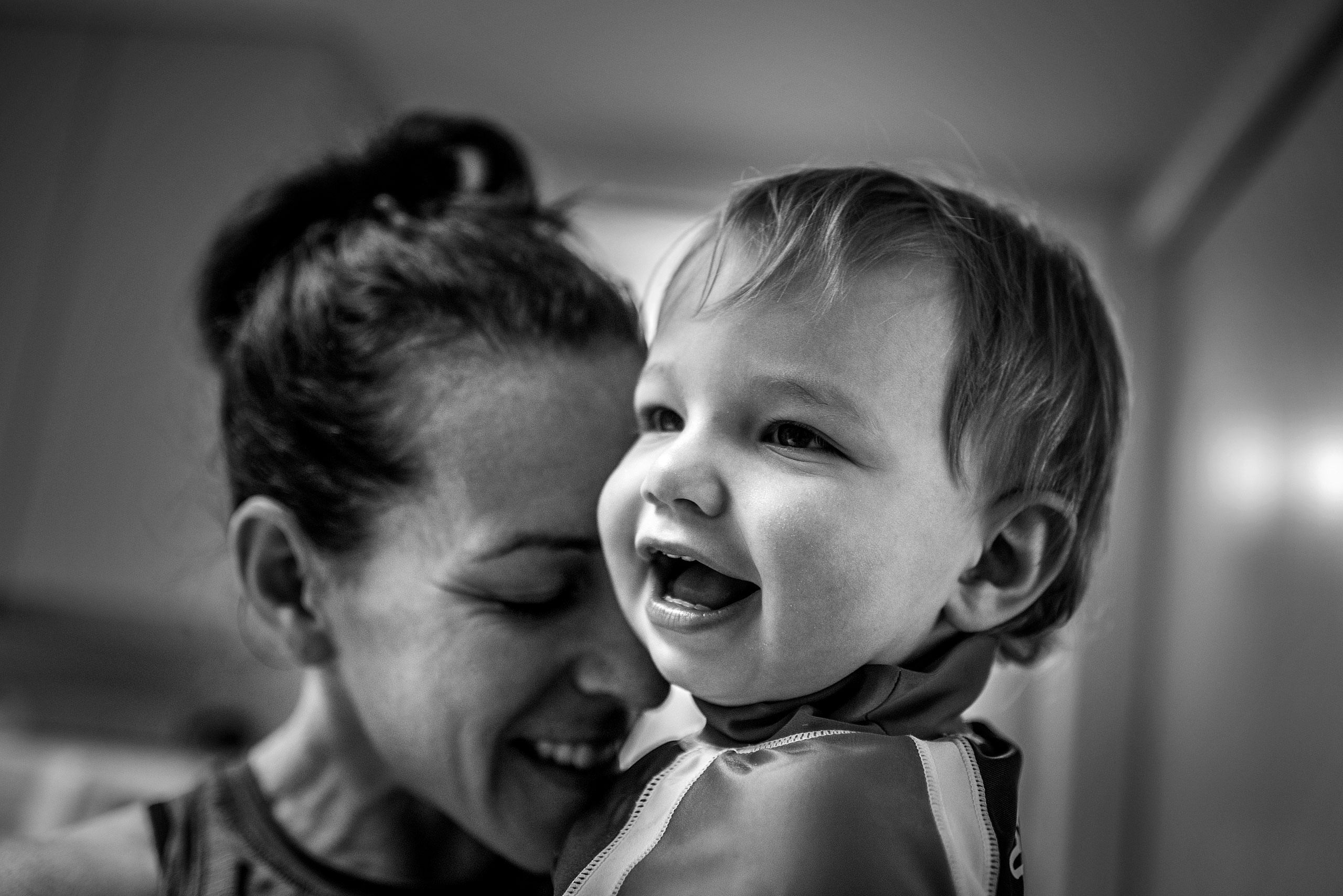 a mom holding her young son by destination family photographers sean leblanc