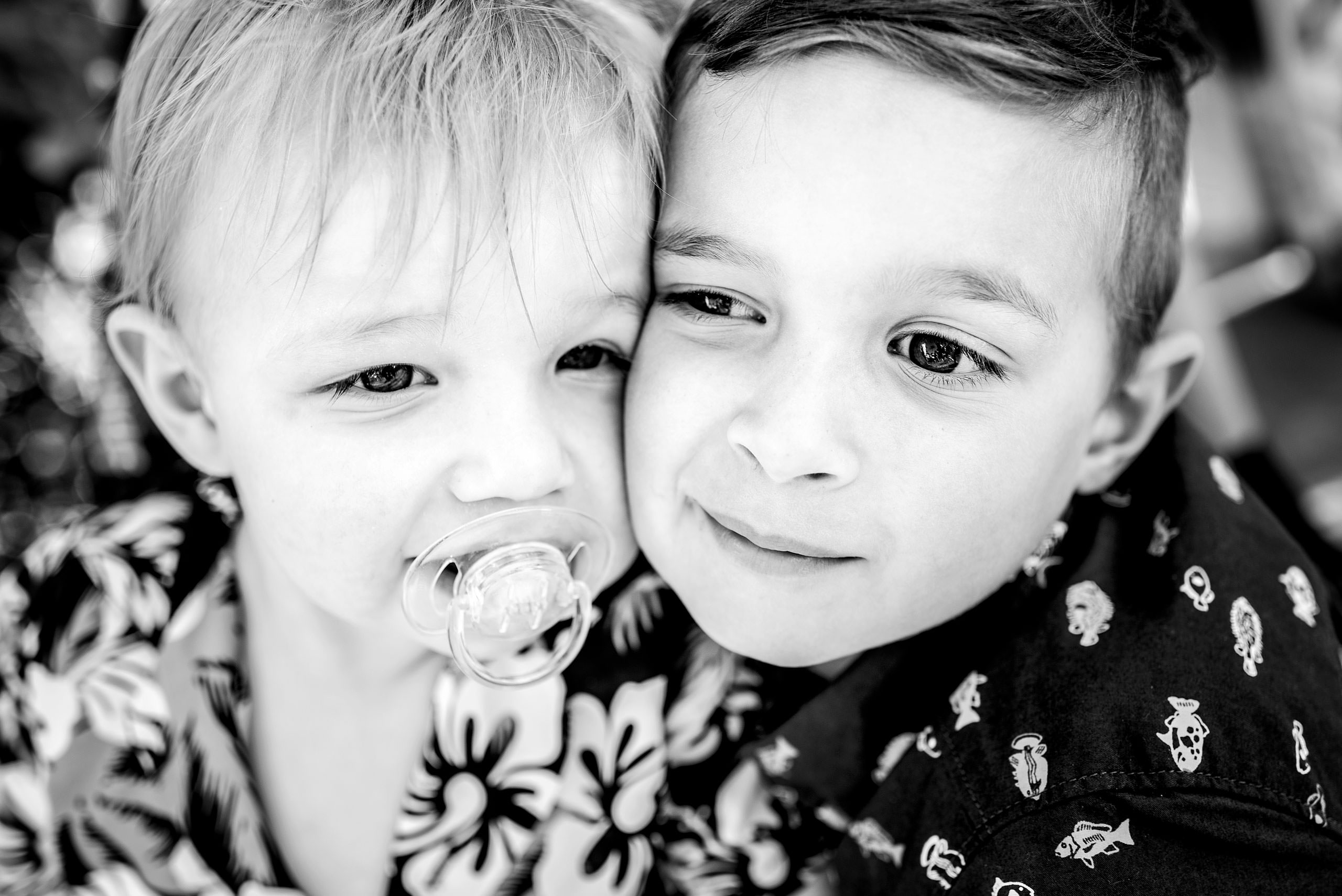 two brothers with their faces close together by destination family photographers sean leblanc