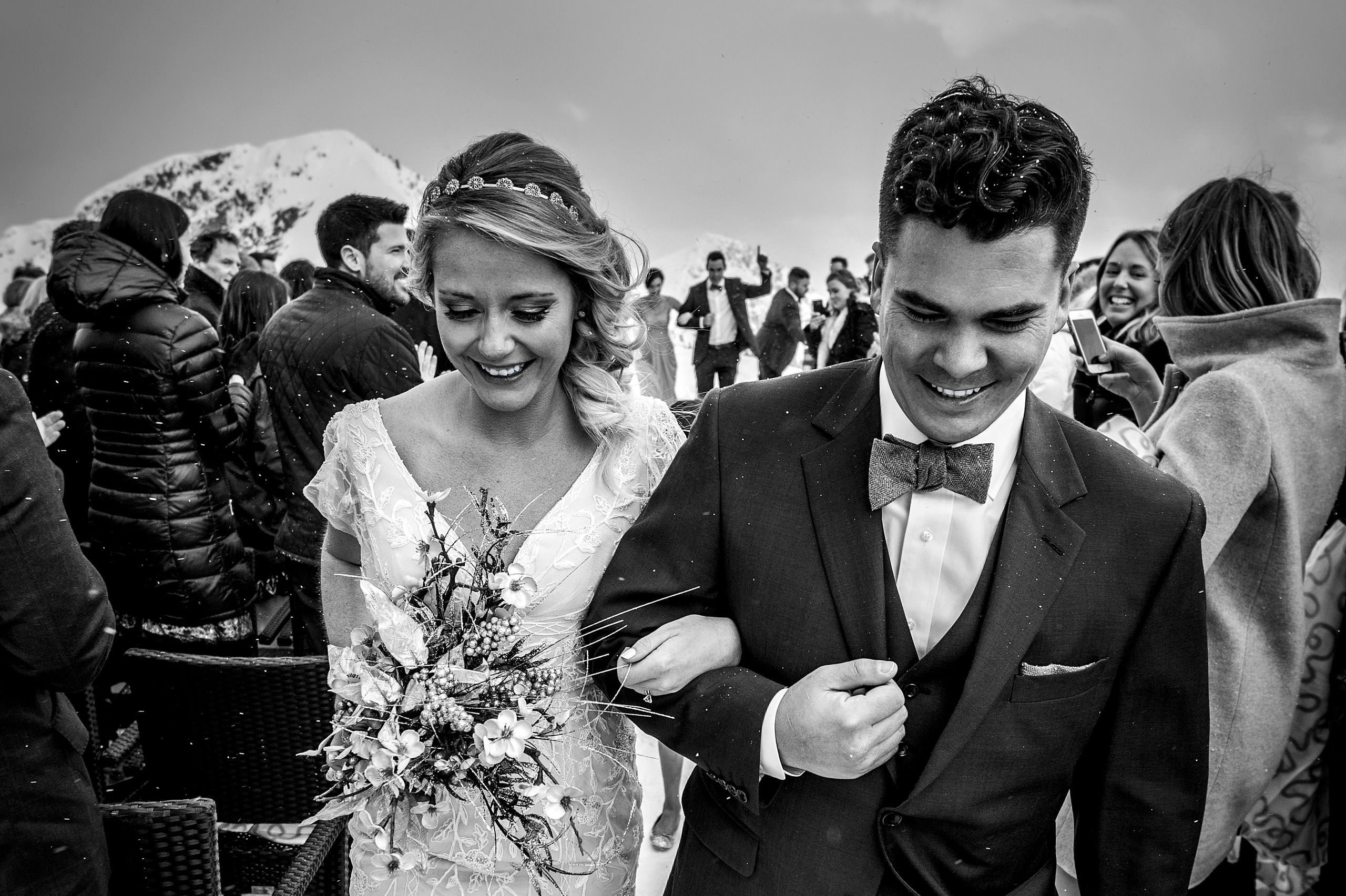 a bride and groom walking arm in arm at a winter kicking horse wedding by sean leblanc