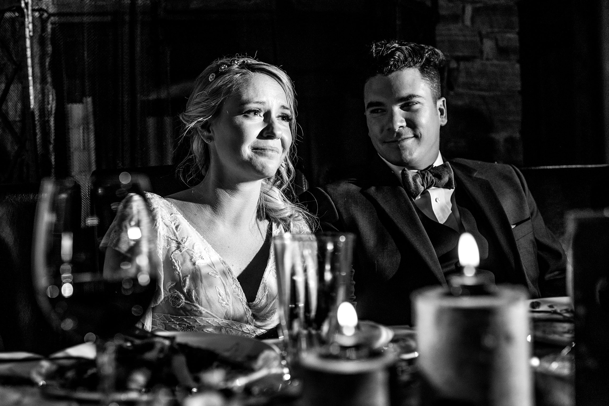 a groom looking at his bride crying at a winter kicking horse wedding by sean leblanc