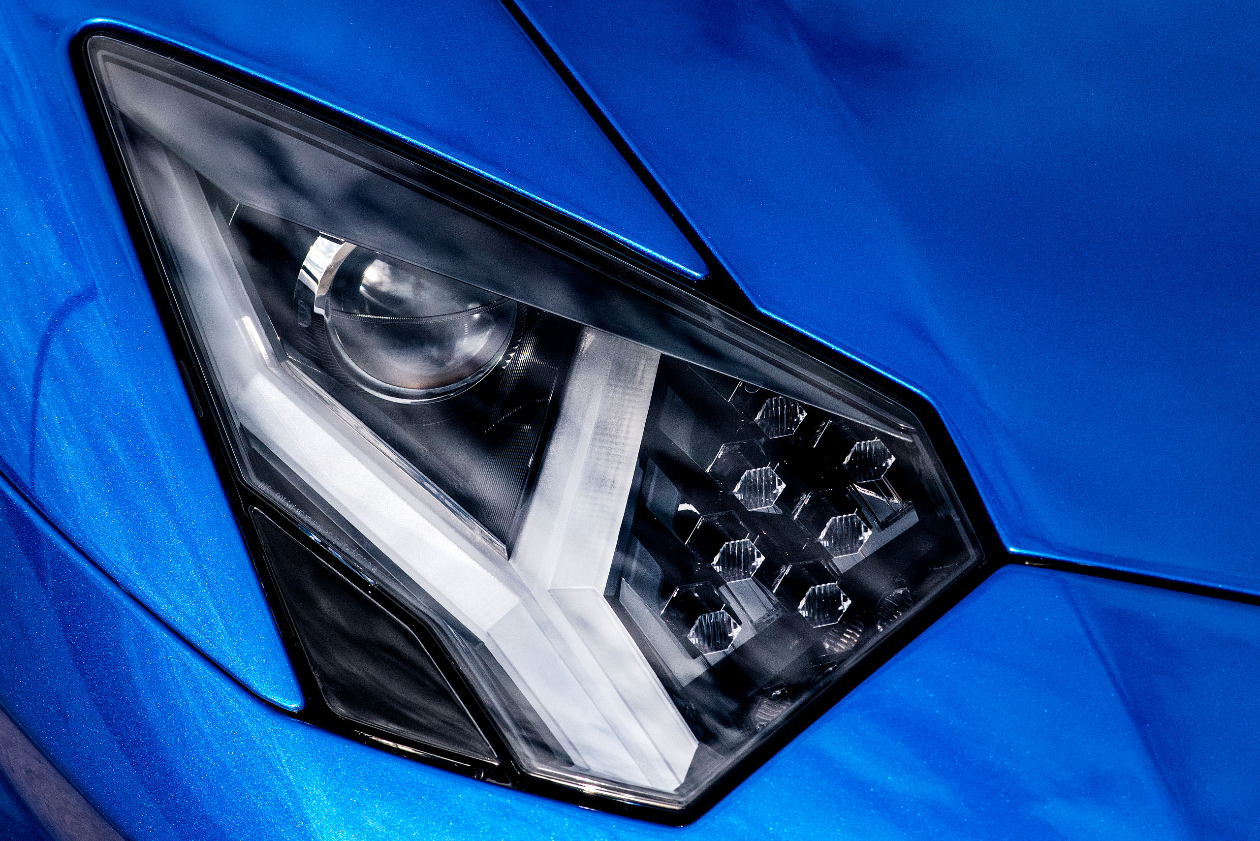 metallic blue Lamborghini aventador close up photograph of the headlight