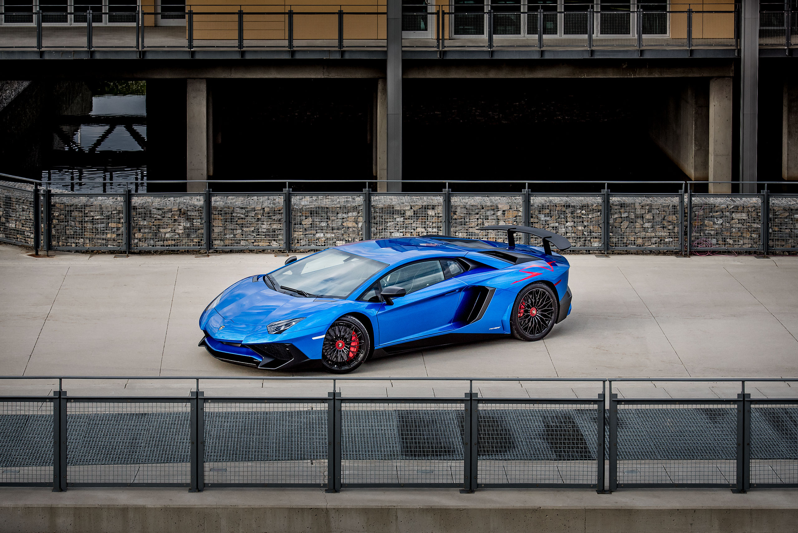 metallic blue Lamborghini aventador with the doors open parked on a road