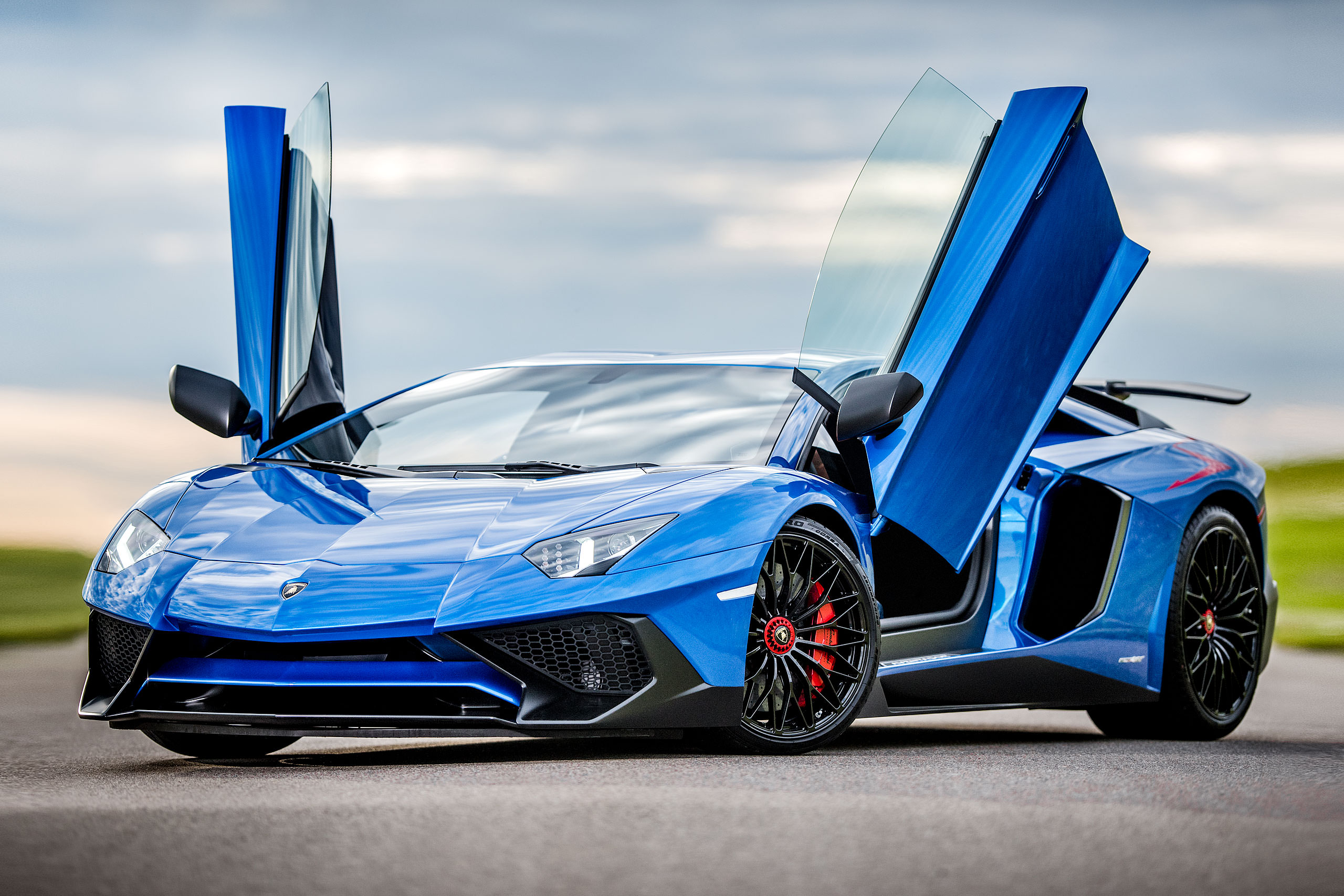 calgary Lamborghini photographer - metallic blue Lamborghini aventador with the doors open parked on a road