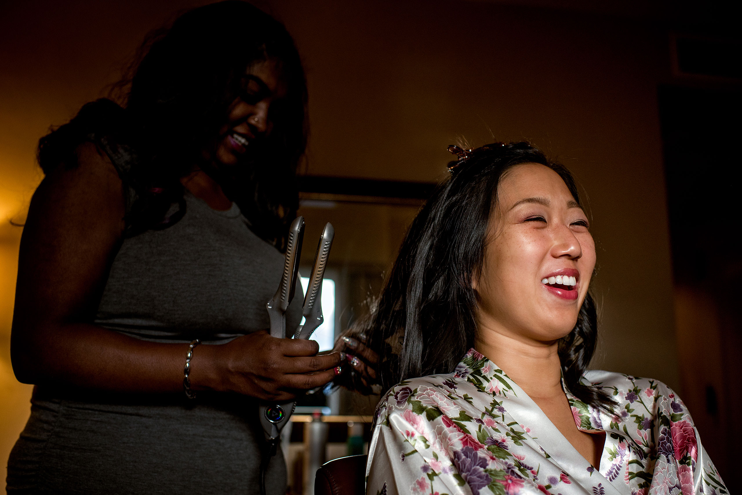 a bride laughing while have her hair done for cascade ballroom banff springs wedding by sean leblanc