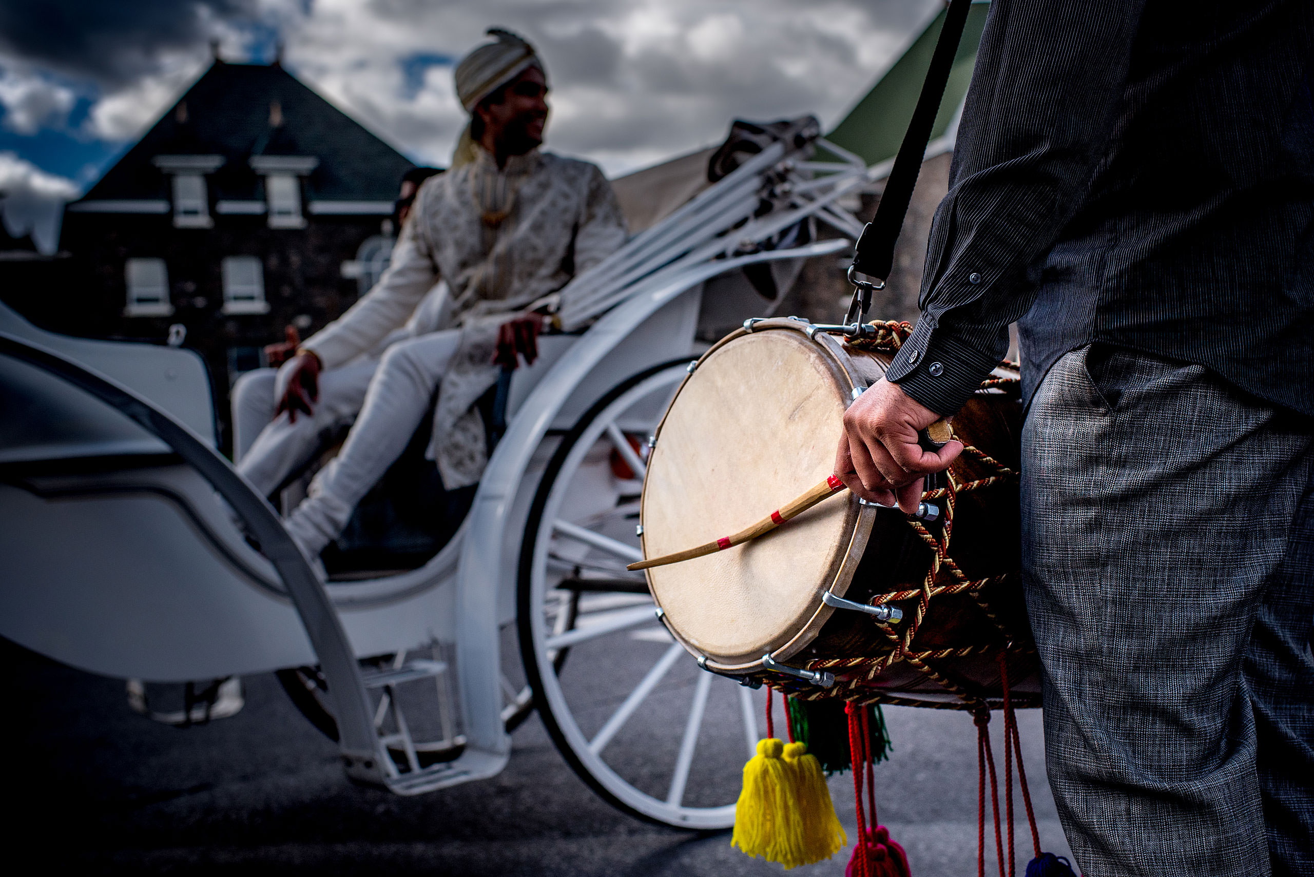 a drum being played with indian groom in background for cascade ballroom banff springs wedding by sean leblanc