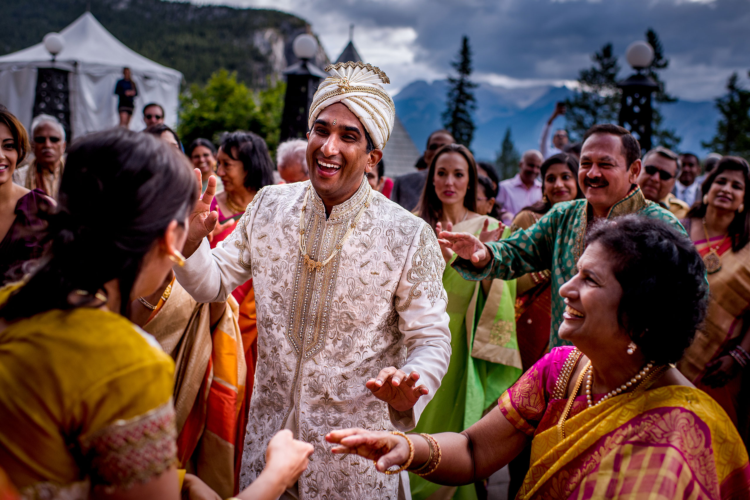 indian groom laughing with relatives for cascade ballroom banff springs wedding by sean leblanc