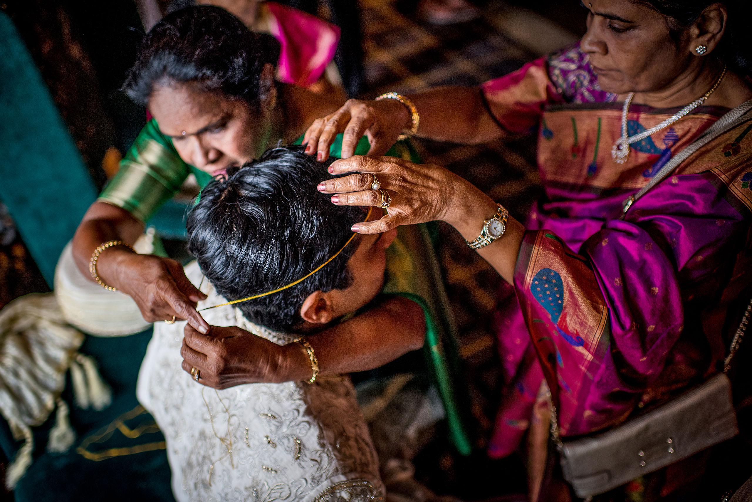 family helping indian groom get ready for cascade ballroom banff springs wedding by sean leblanc