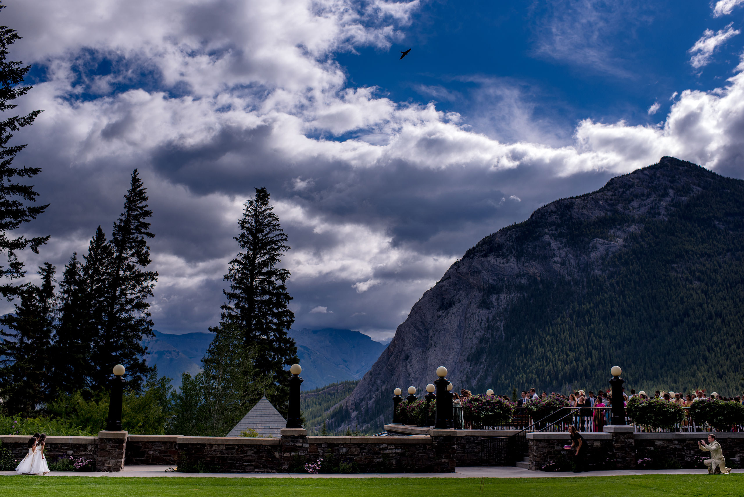 flowers girls walking down the aisle at ceremony for cascade ballroom banff springs wedding by sean leblanc