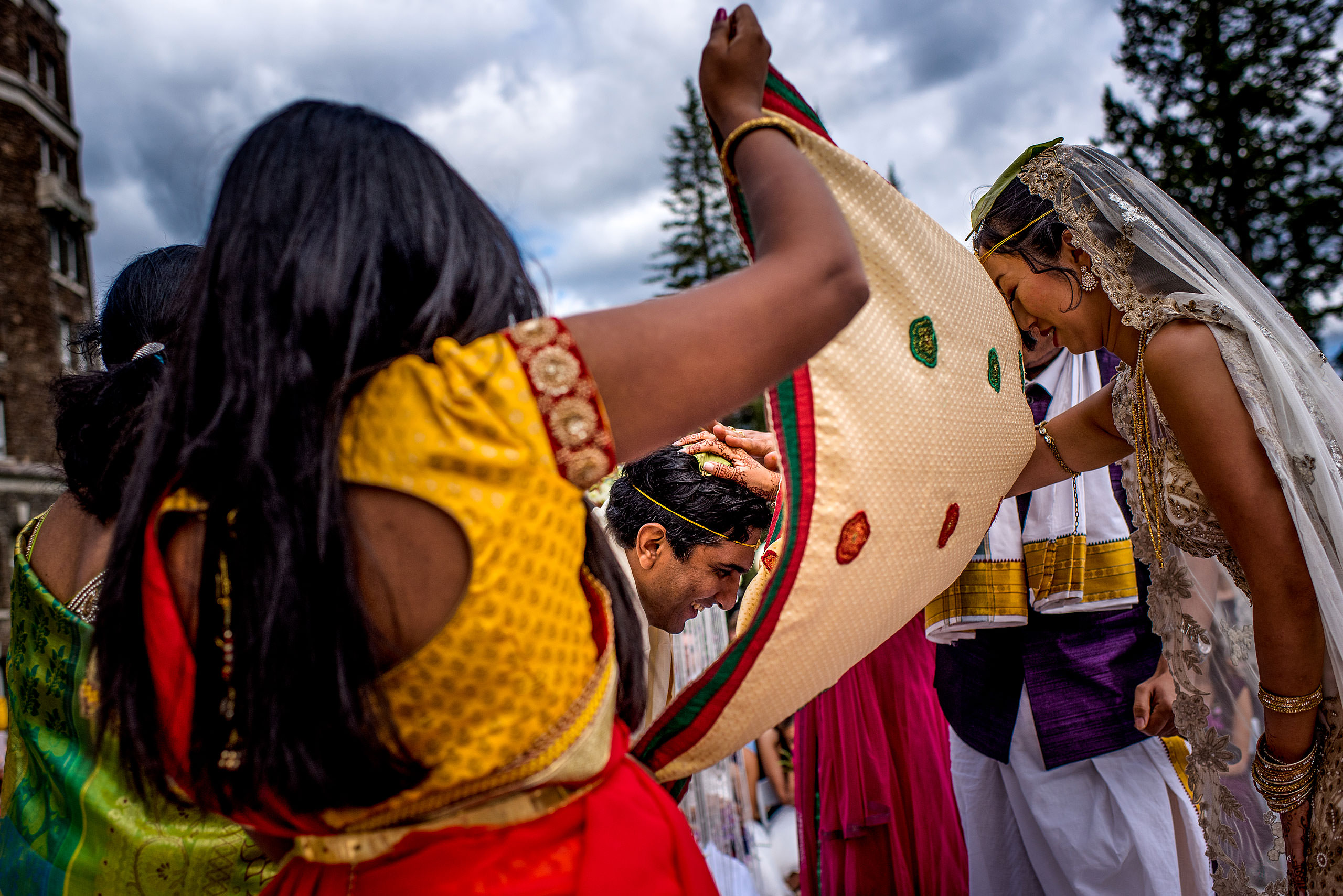 bride placing hand on grooms head for cascade ballroom banff springs wedding by sean leblanc