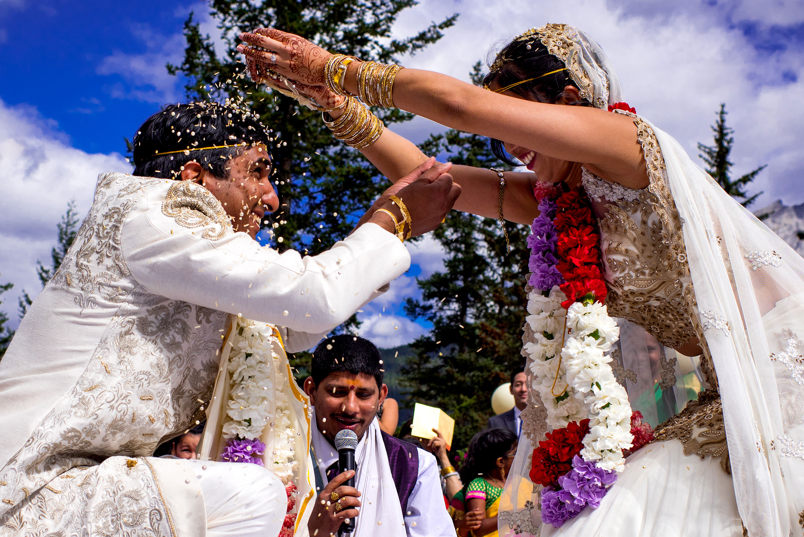 bride and groom throwing beads at each other for cascade ballroom banff springs wedding by sean leblanc