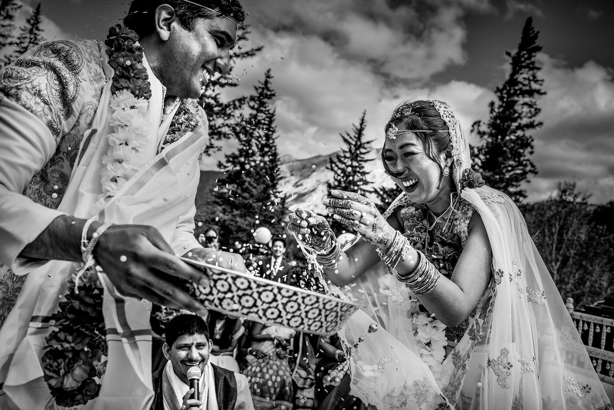 bride and groom throwing beads at each other for cascade ballroom banff springs wedding by sean leblanc