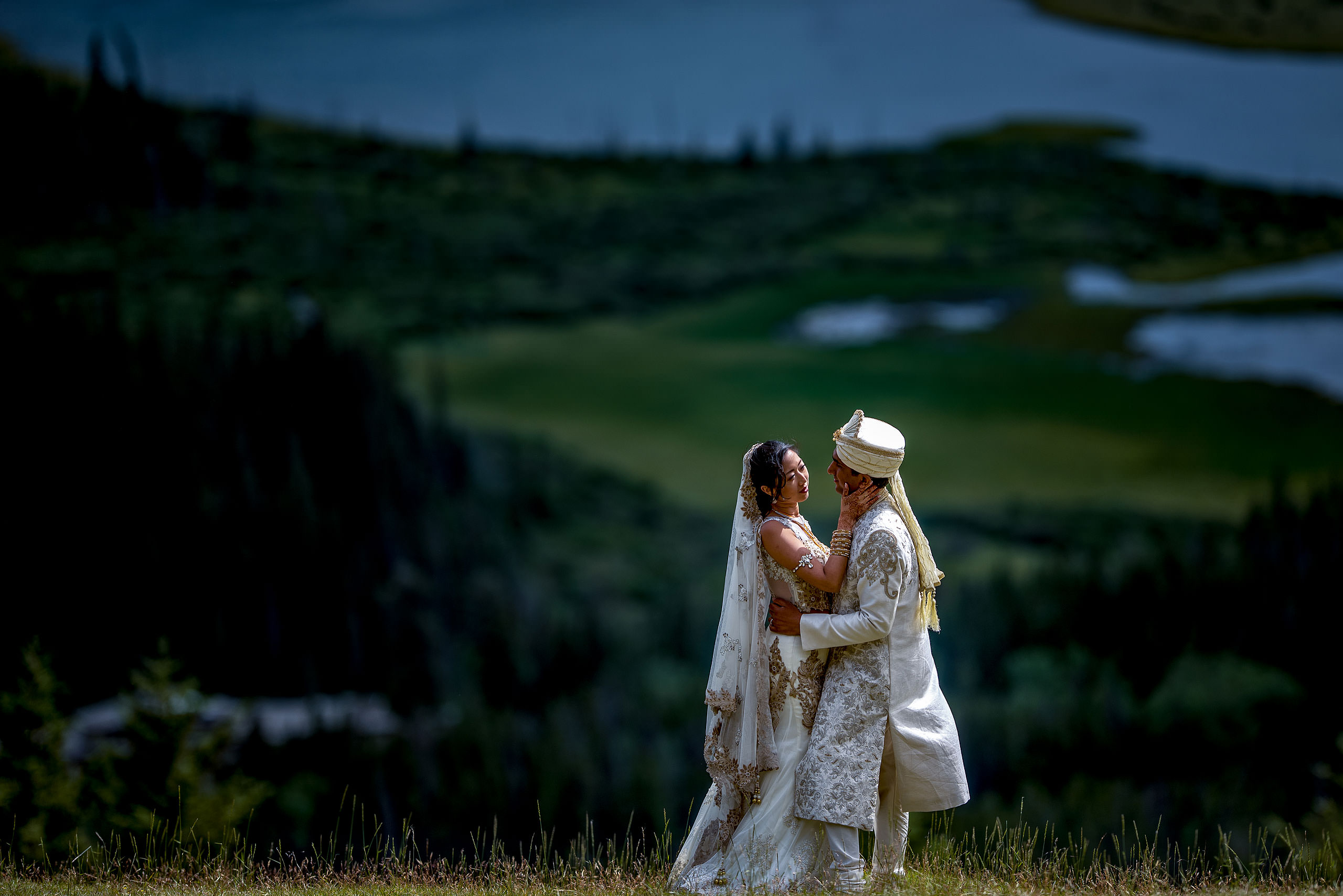 bride and groom embracing each other on a mountain for cascade ballroom banff springs wedding by sean leblanc