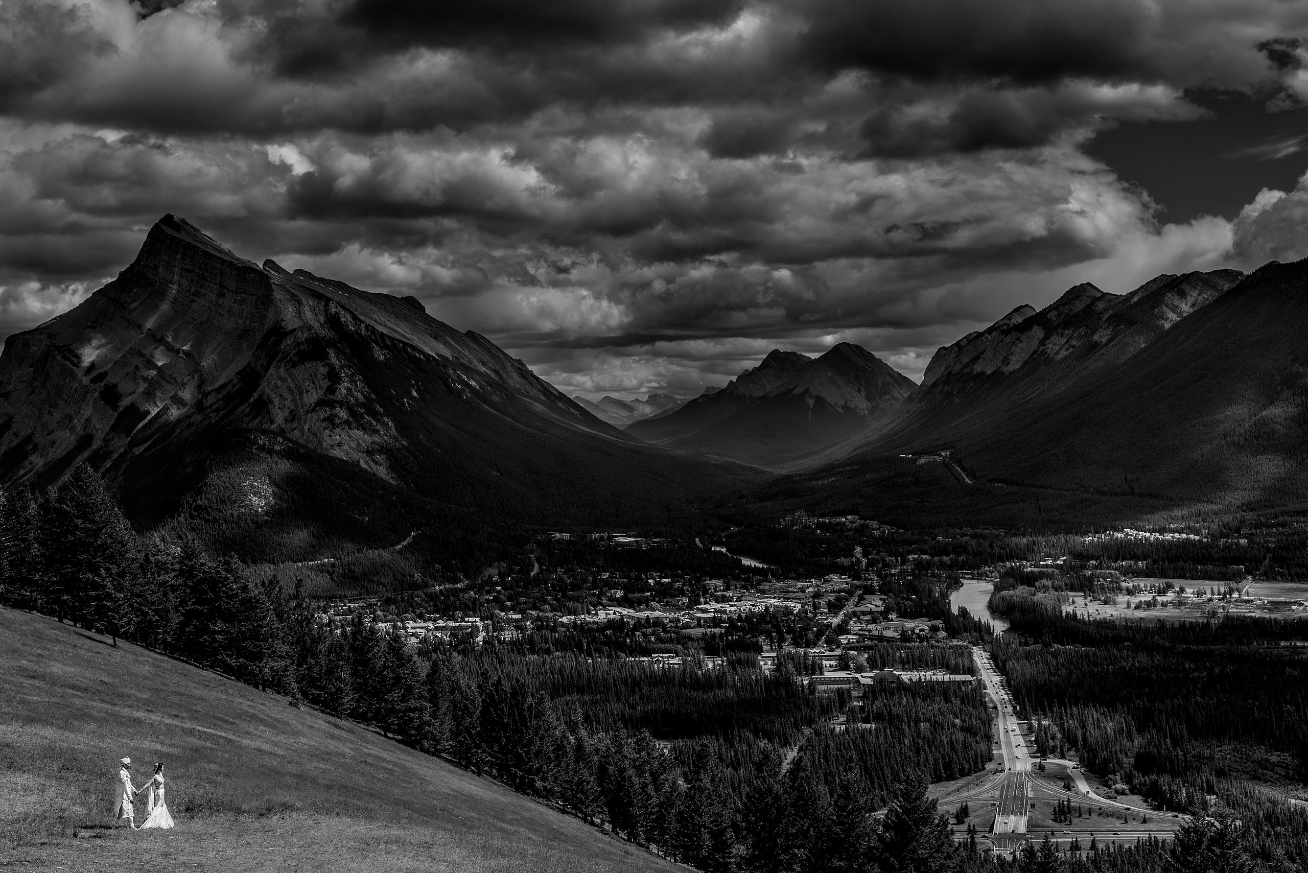 bride and groom walking down a mountain for cascade ballroom banff springs wedding by sean leblanc