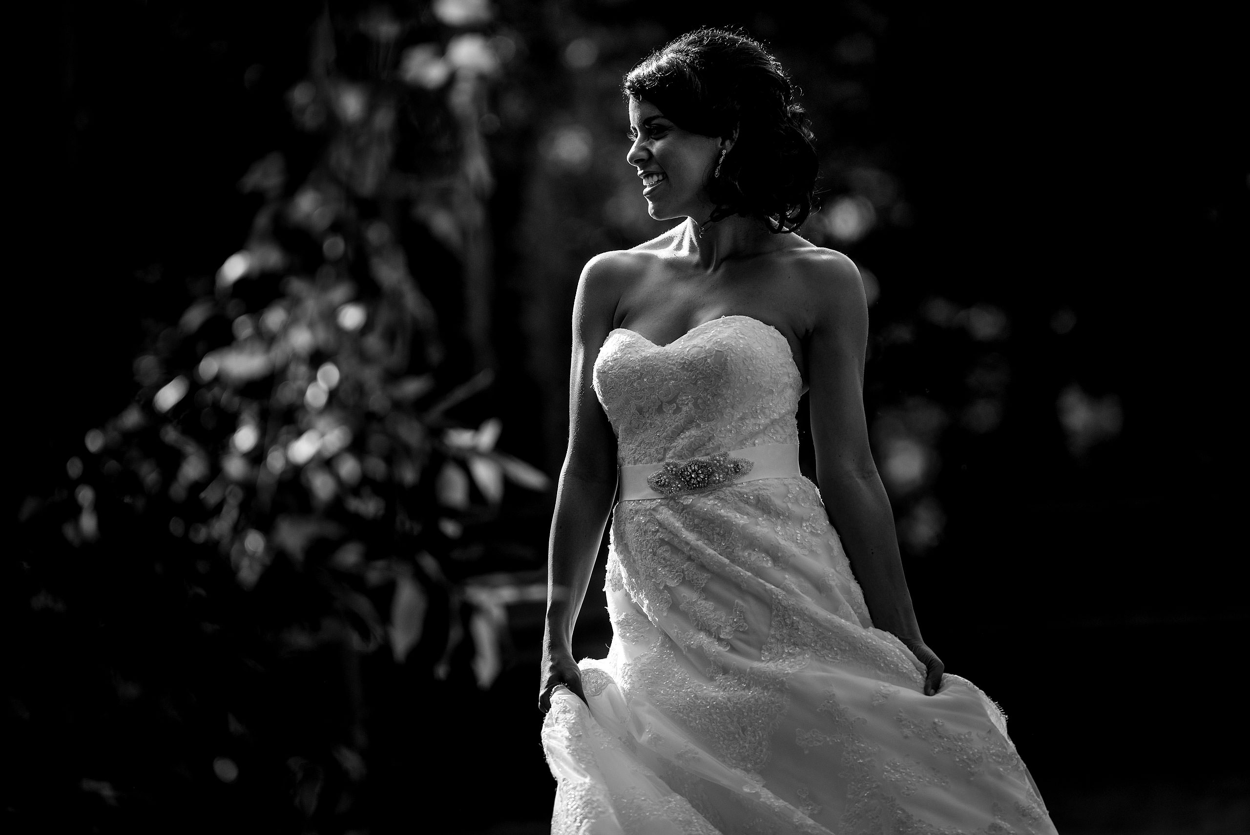 a bride swaying her dress in a park by Edmonton wedding photographer sean leblanc