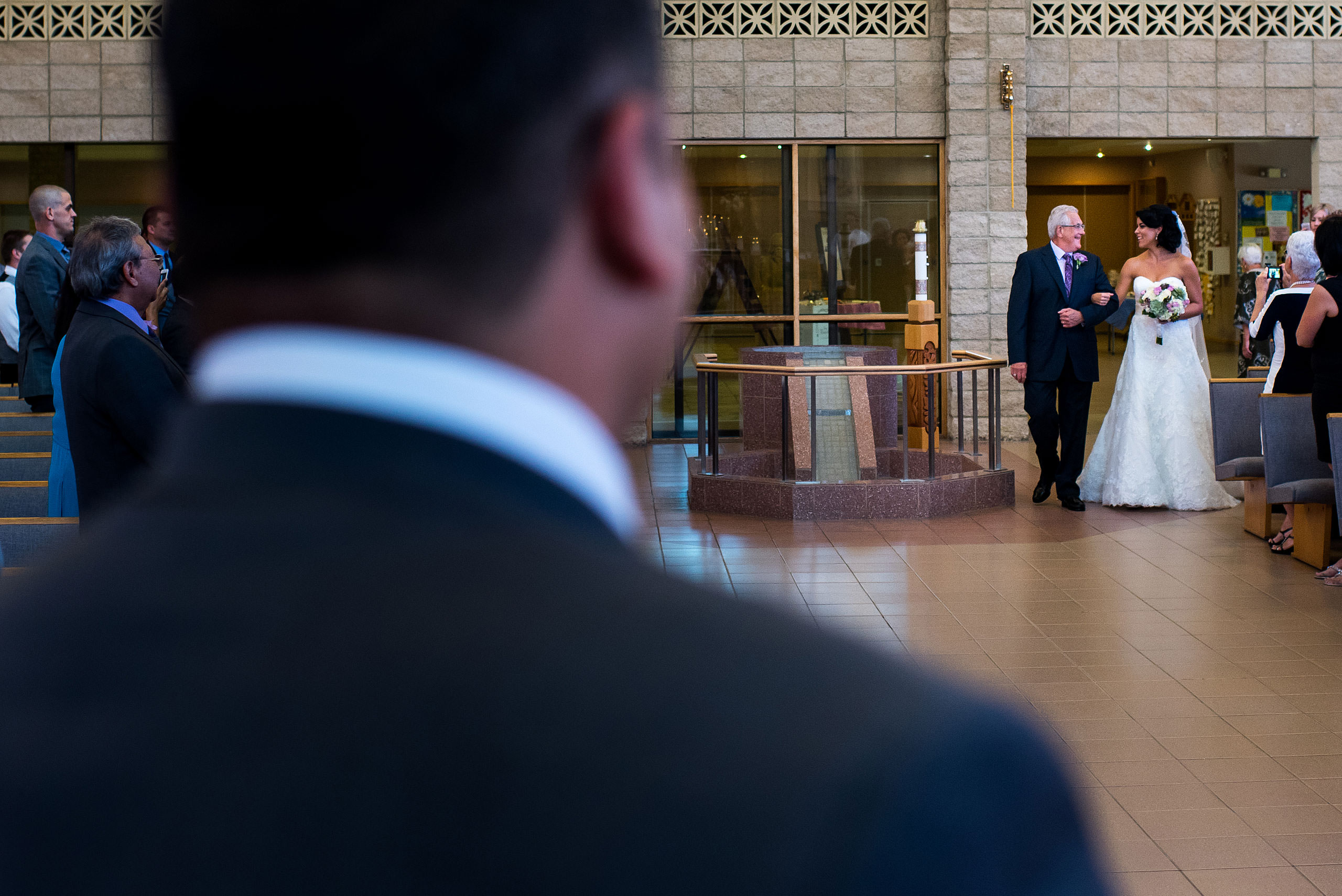 a bride and her dad walking down the aisle at a ceremony by Edmonton wedding photographer sean leblanc