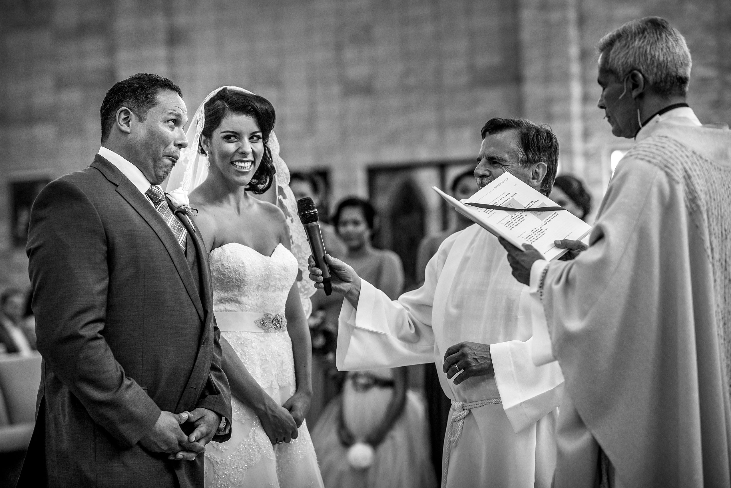 a groom making a funny face to his bride at a ceremony by Edmonton wedding photographer sean leblanc