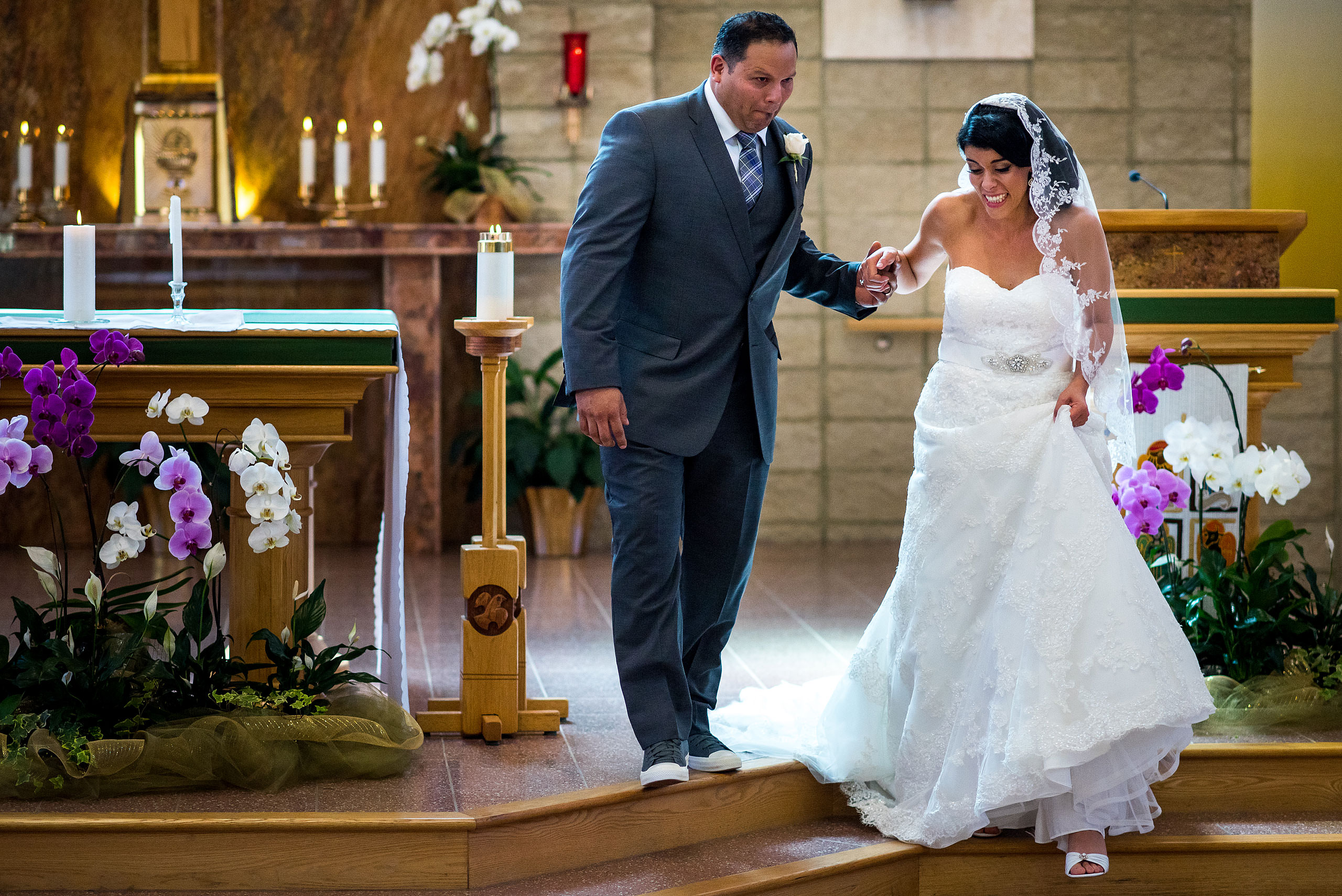 a groom stepping on a brides dress by Edmonton wedding photographer sean leblanc