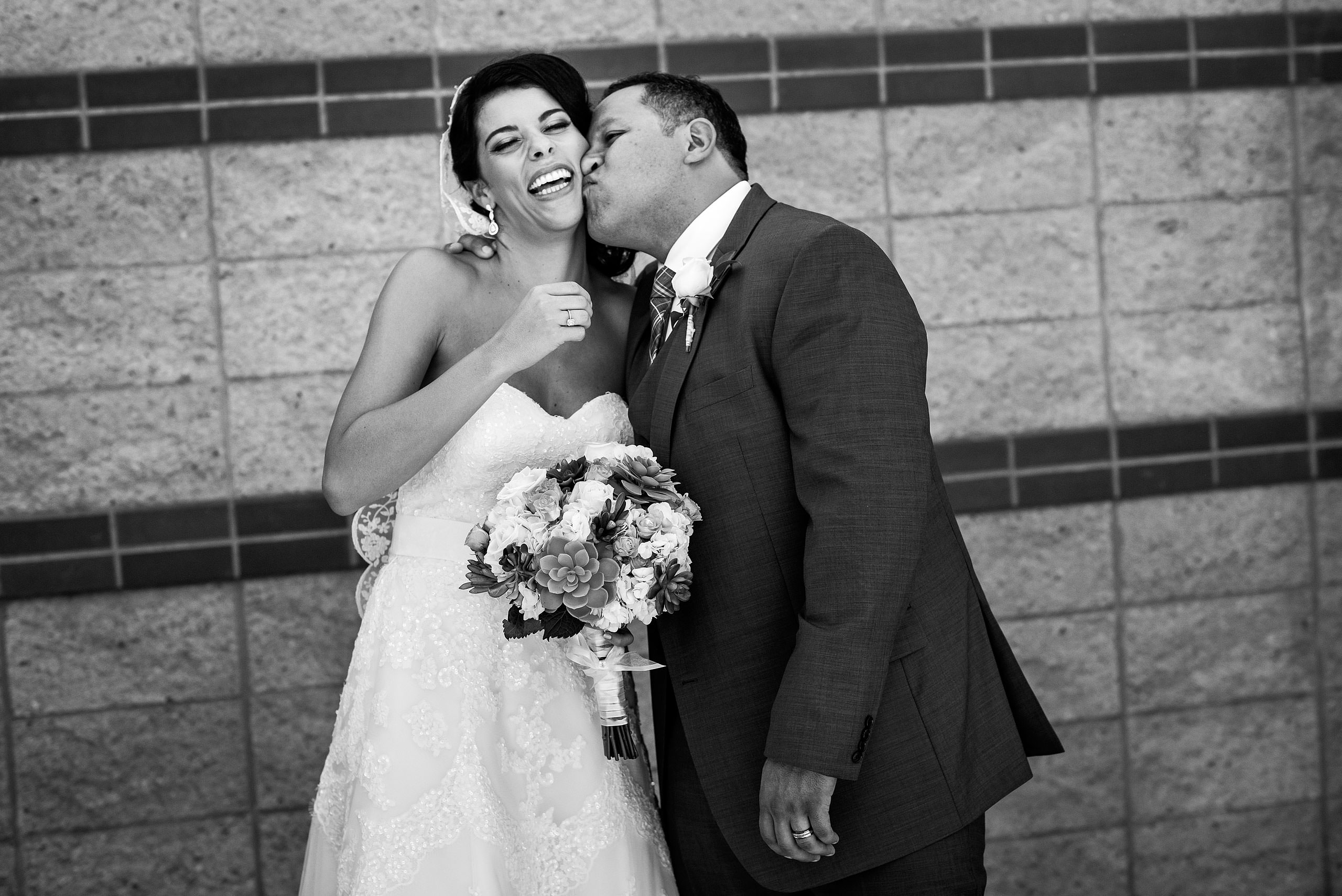 a groom kissing a bride on the cheek by Edmonton wedding photographer sean leblanc