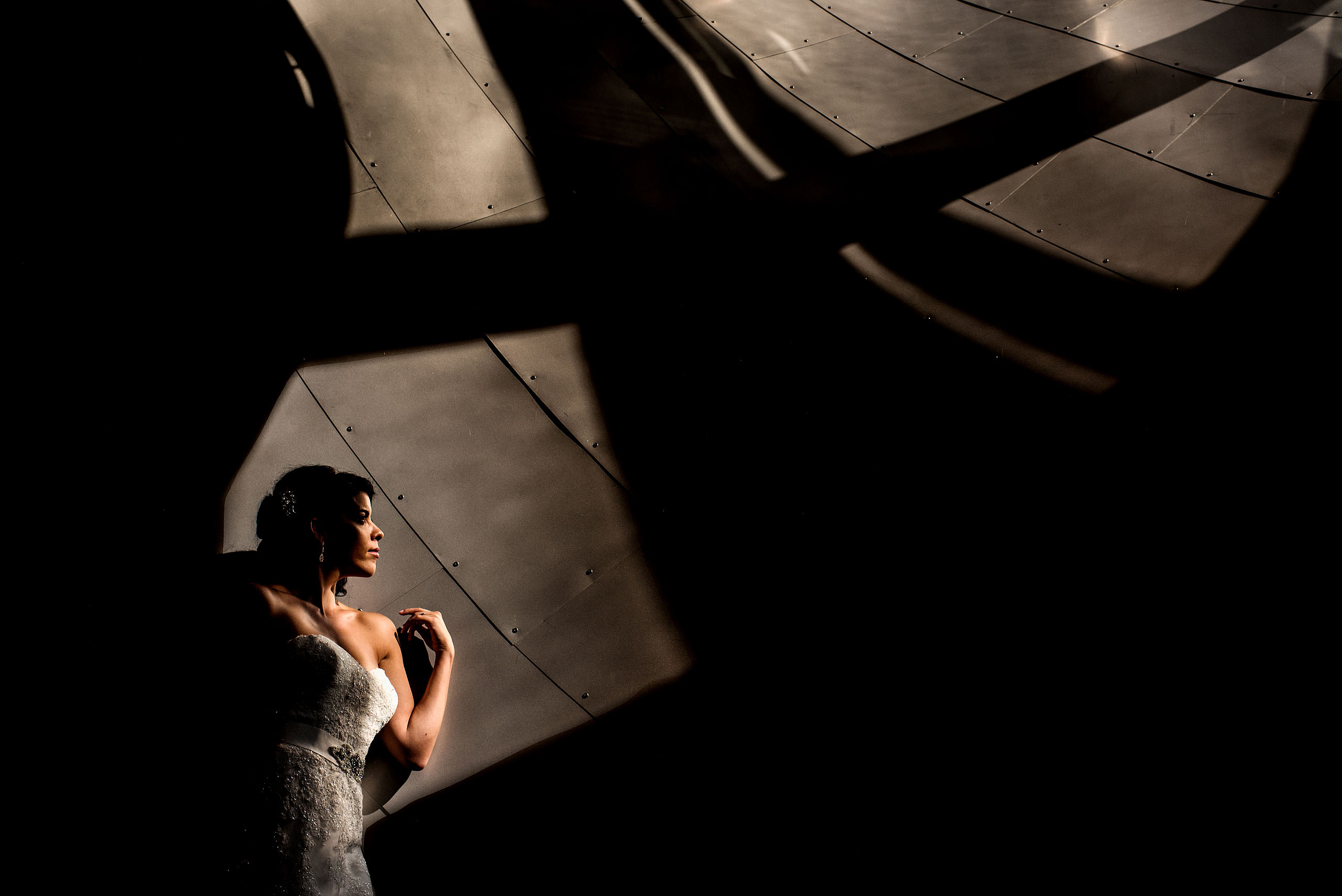 a bride leaning up against a wall at the Art Gallery of Alberta by Edmonton wedding photographer sean leblanc