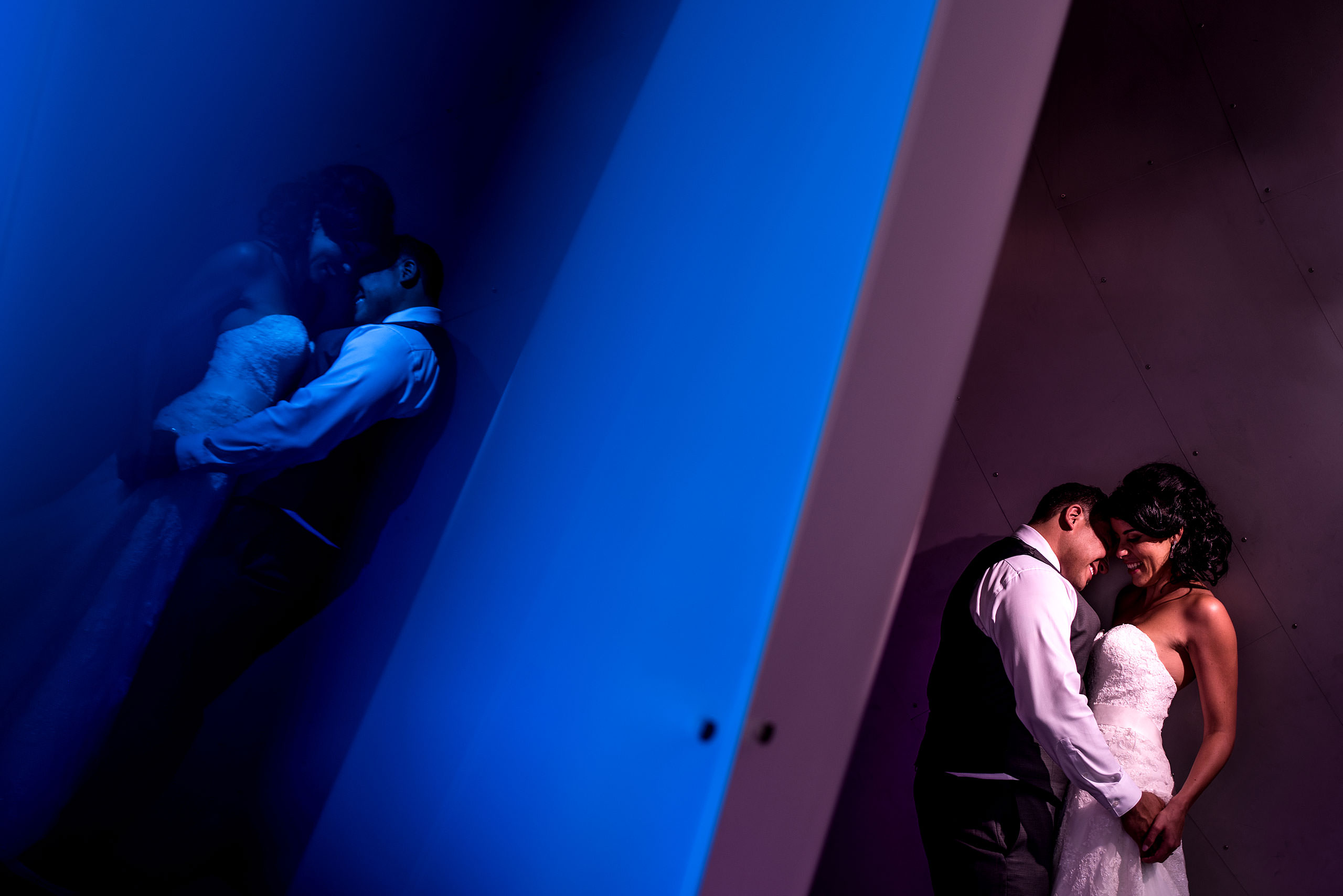 a bride and groom embracing at the Art Gallery of Alberta by Edmonton wedding photographer sean leblanc