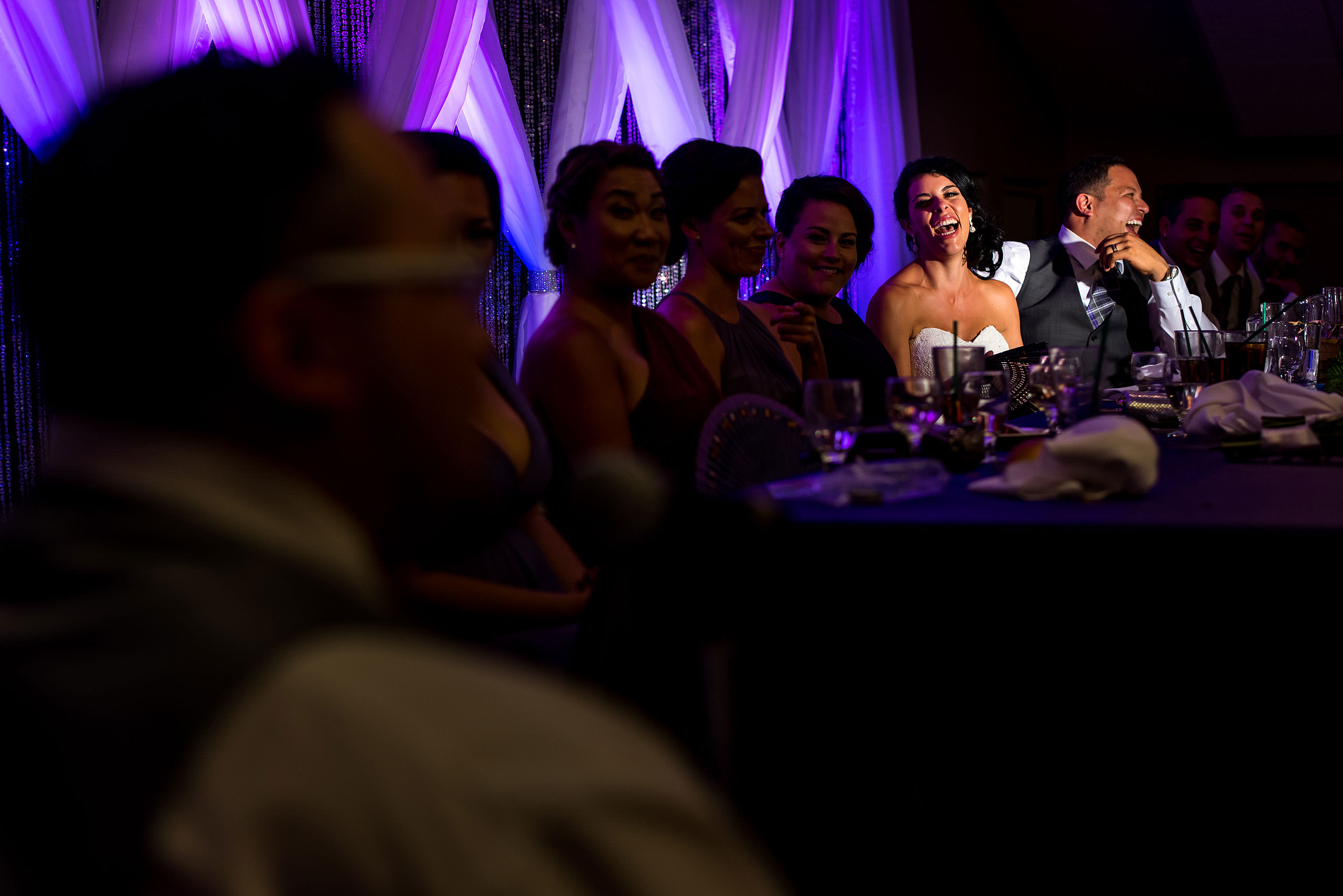 a bride and groom laughing at a speech by Edmonton wedding photographer sean leblanc