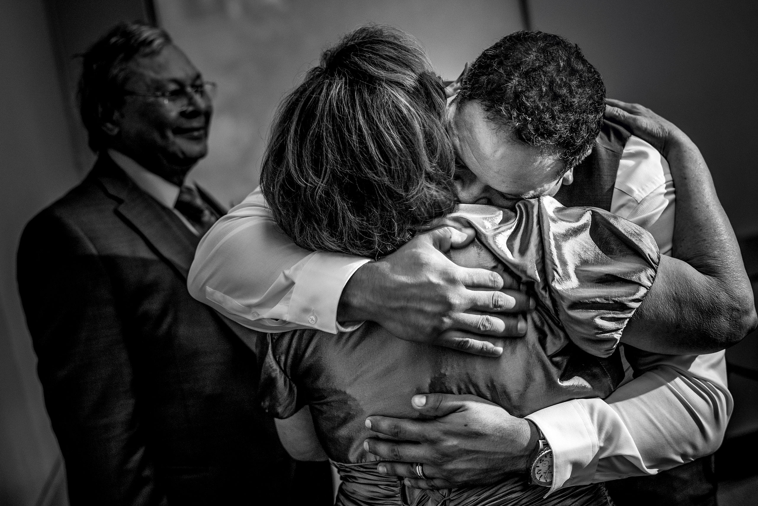 a groom hugging his mom by Edmonton wedding photographer sean leblanc