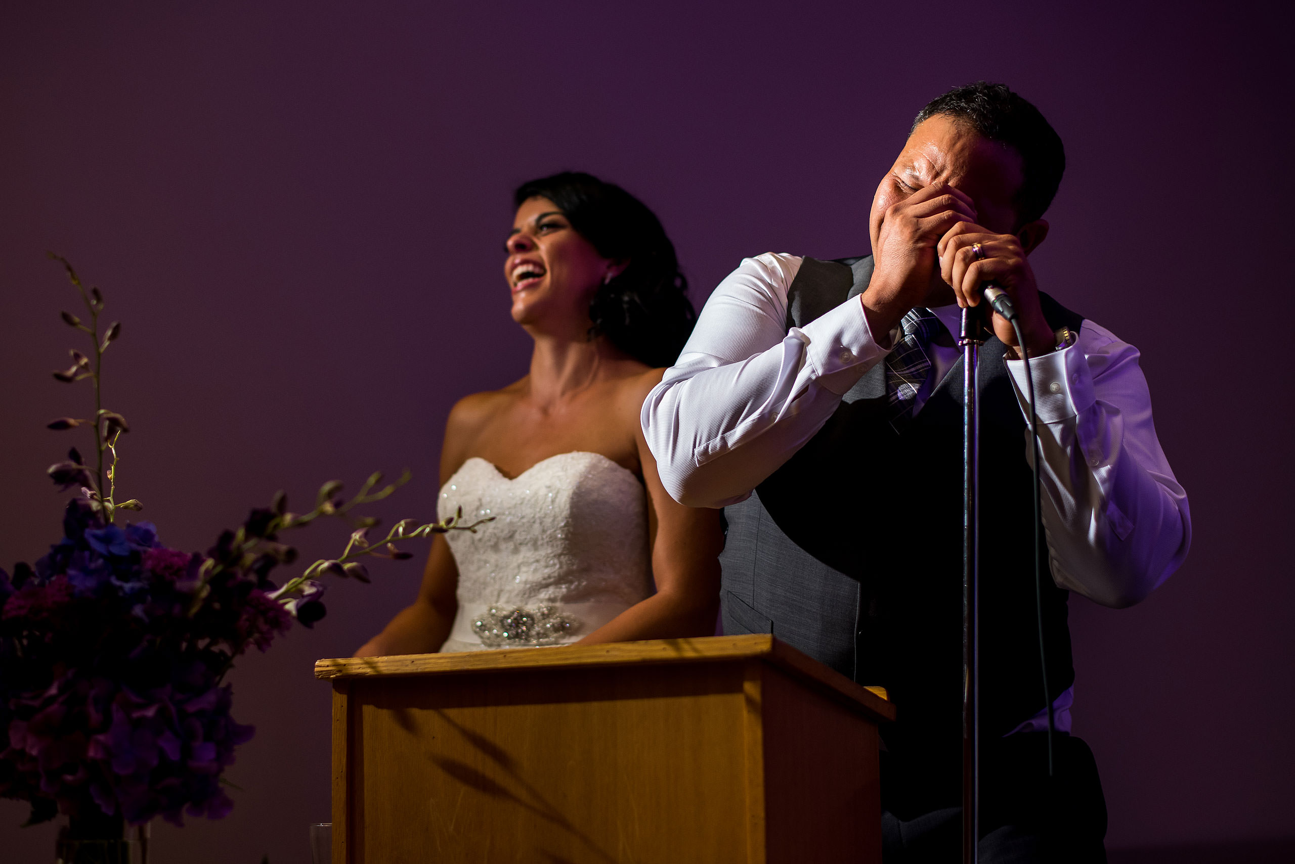 a groom giving a speech with his bride by Edmonton wedding photographer sean leblanc