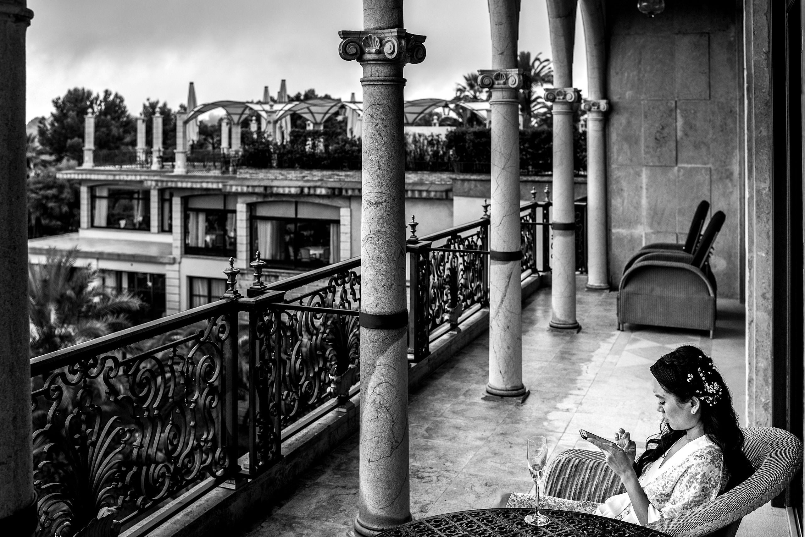 bride sitting on a balcony of a castle hotel at castillo hotel son vida destination wedding by sean leblanc