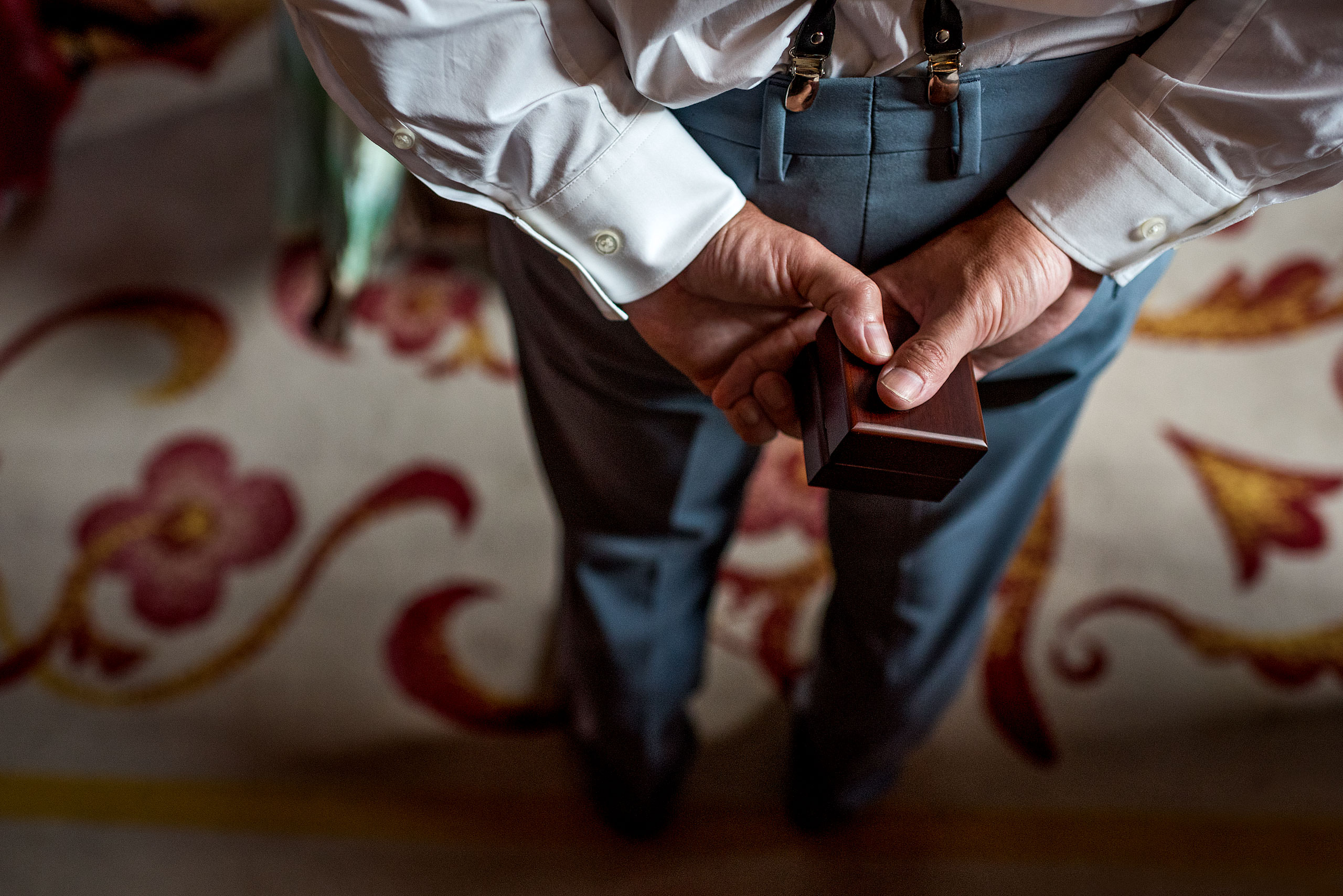 best man holding the rings behind his back at castillo hotel son vida destination wedding by sean leblanc