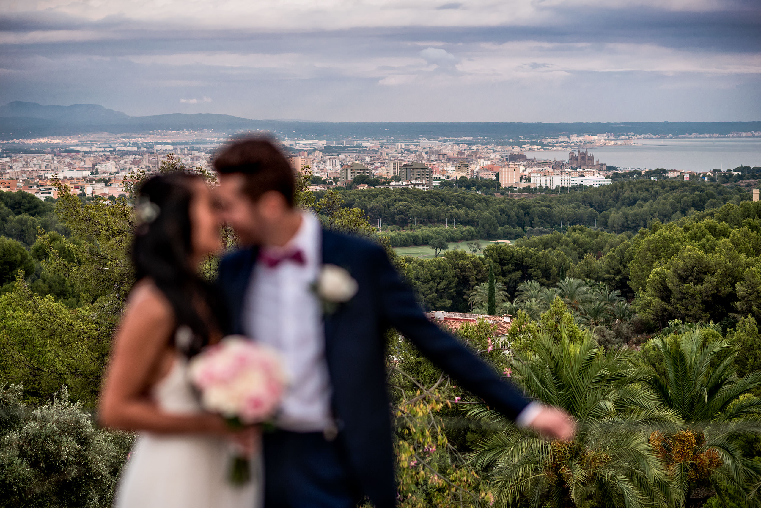 bride and groom with city in the background at castillo hotel son vida destination wedding by sean leblanc