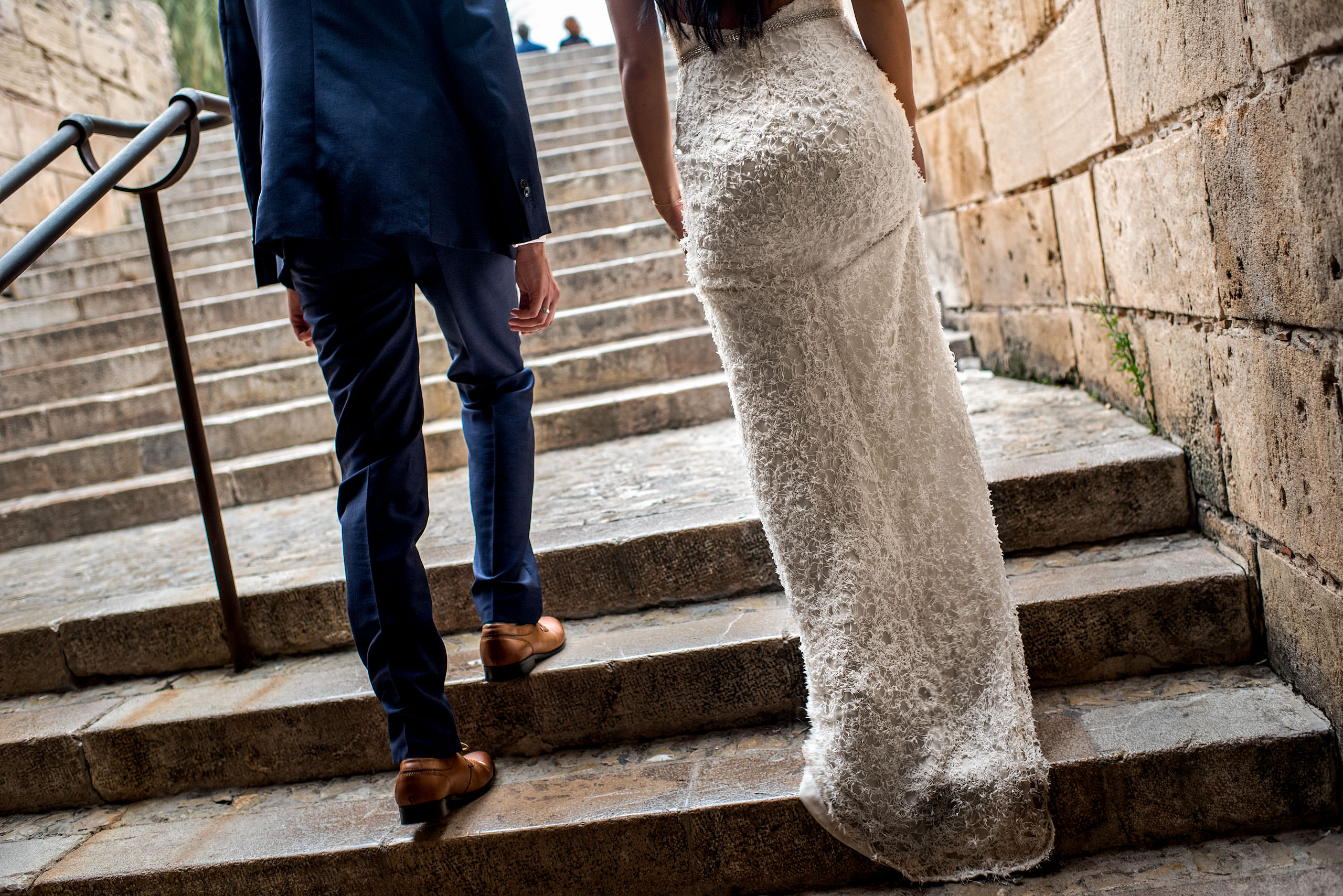 a bride and groom walking up stairs at castillo hotel son vida destination wedding by sean leblanc