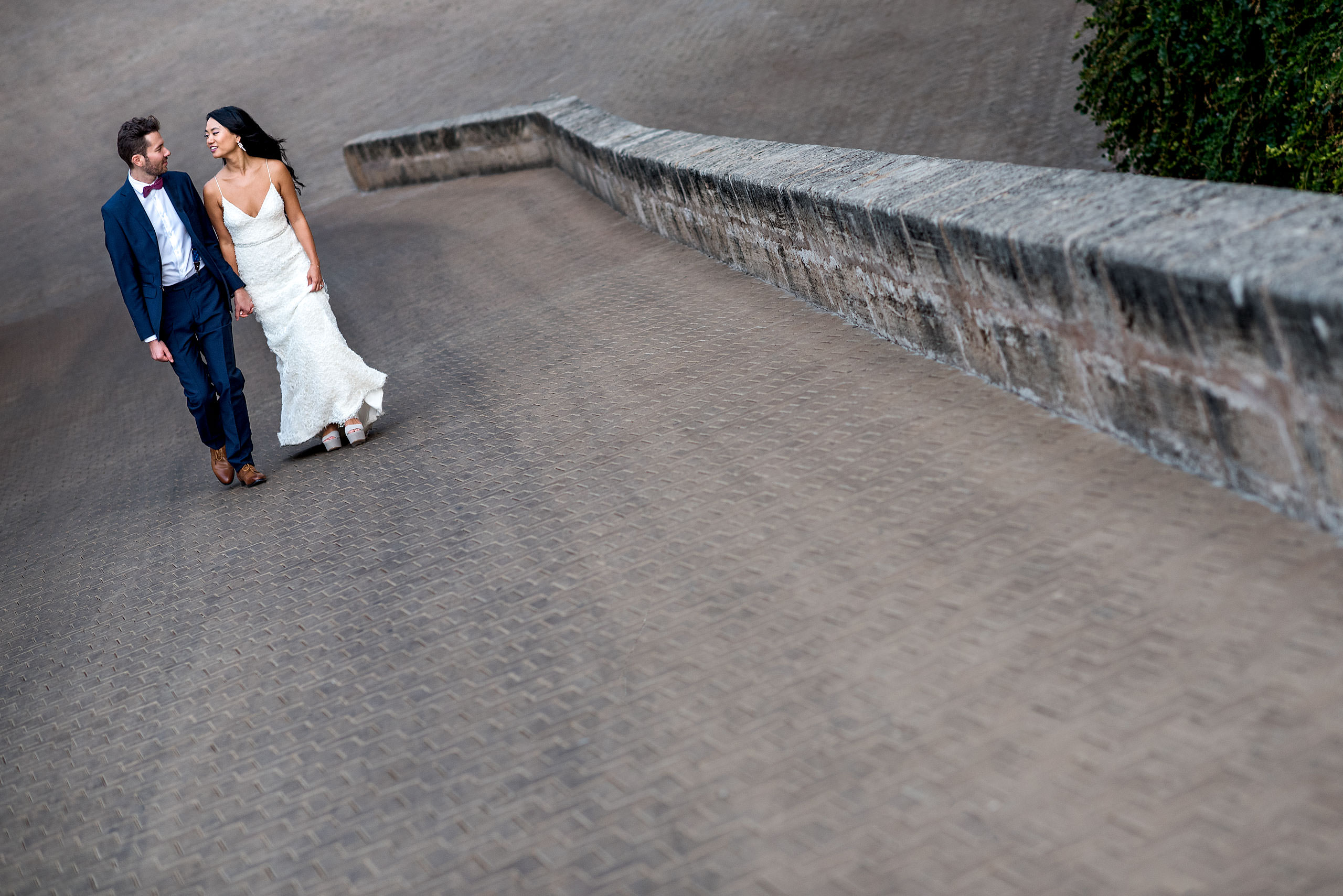 a bride and groom walking up a ramp at castillo hotel son vida destination wedding by sean leblanc