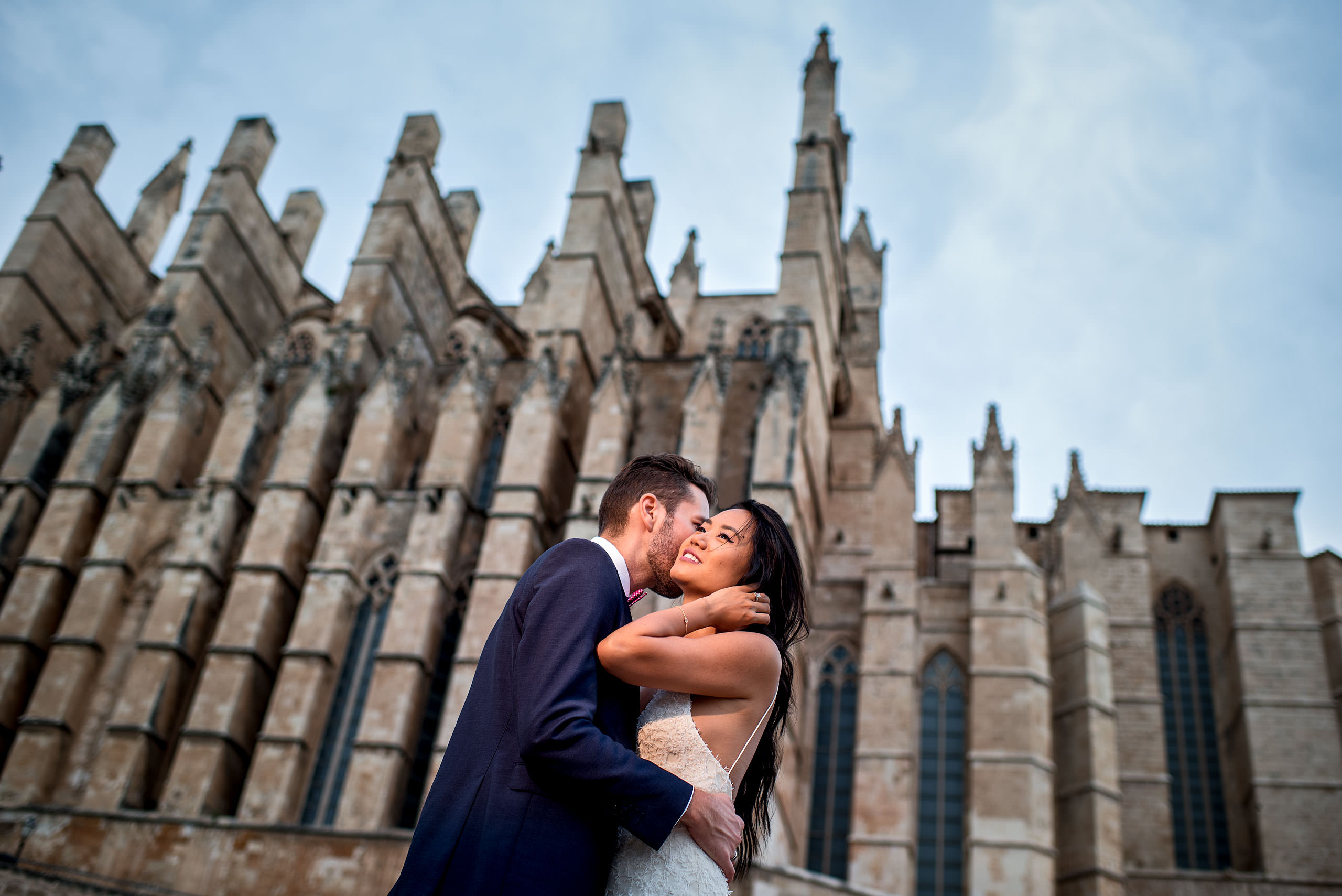 a bride and groom in front of the Palma cathedral at castillo hotel son vida destination wedding by sean leblanc