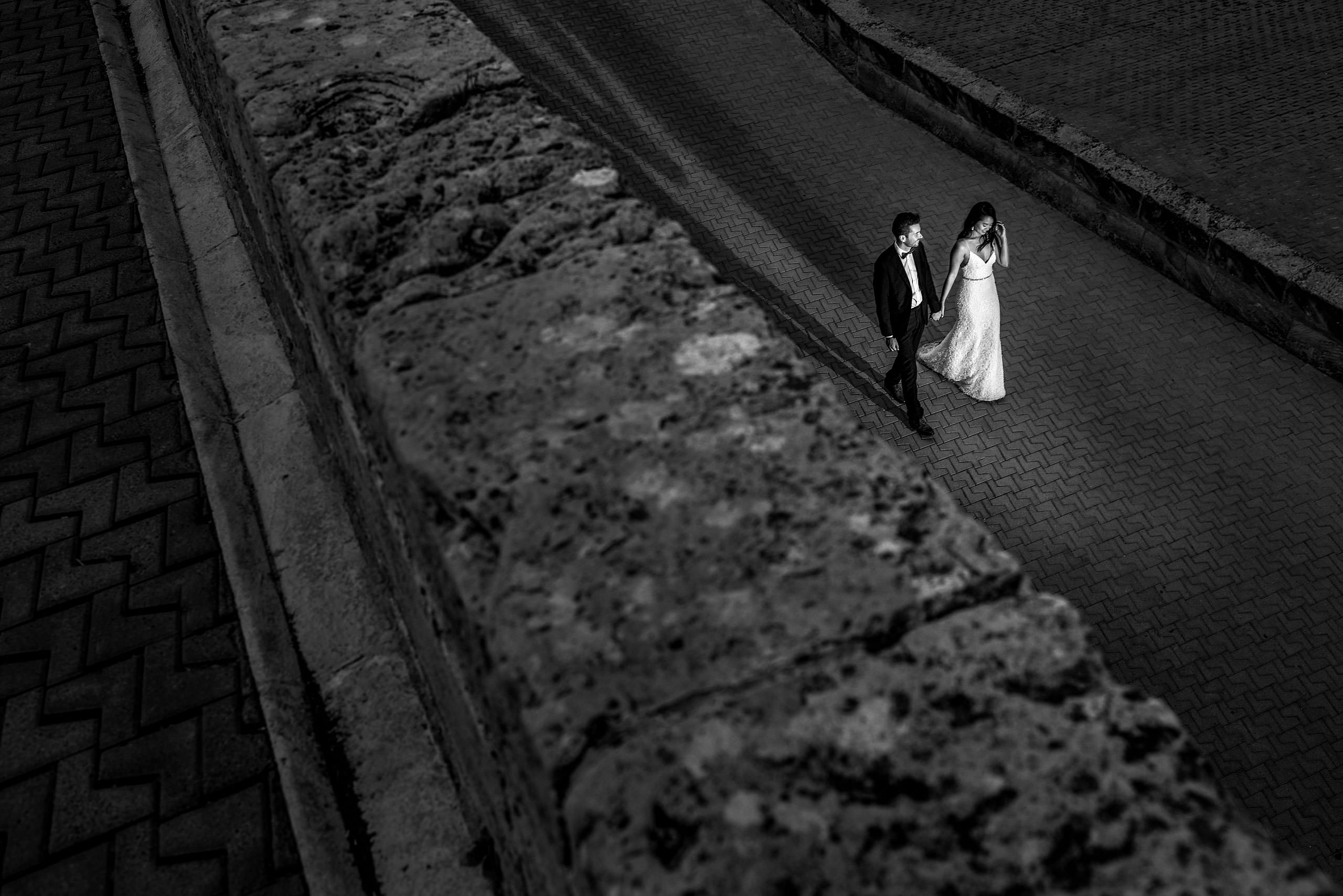 a bride and groom walking up a ramp at castillo hotel son vida destination wedding by sean leblanc