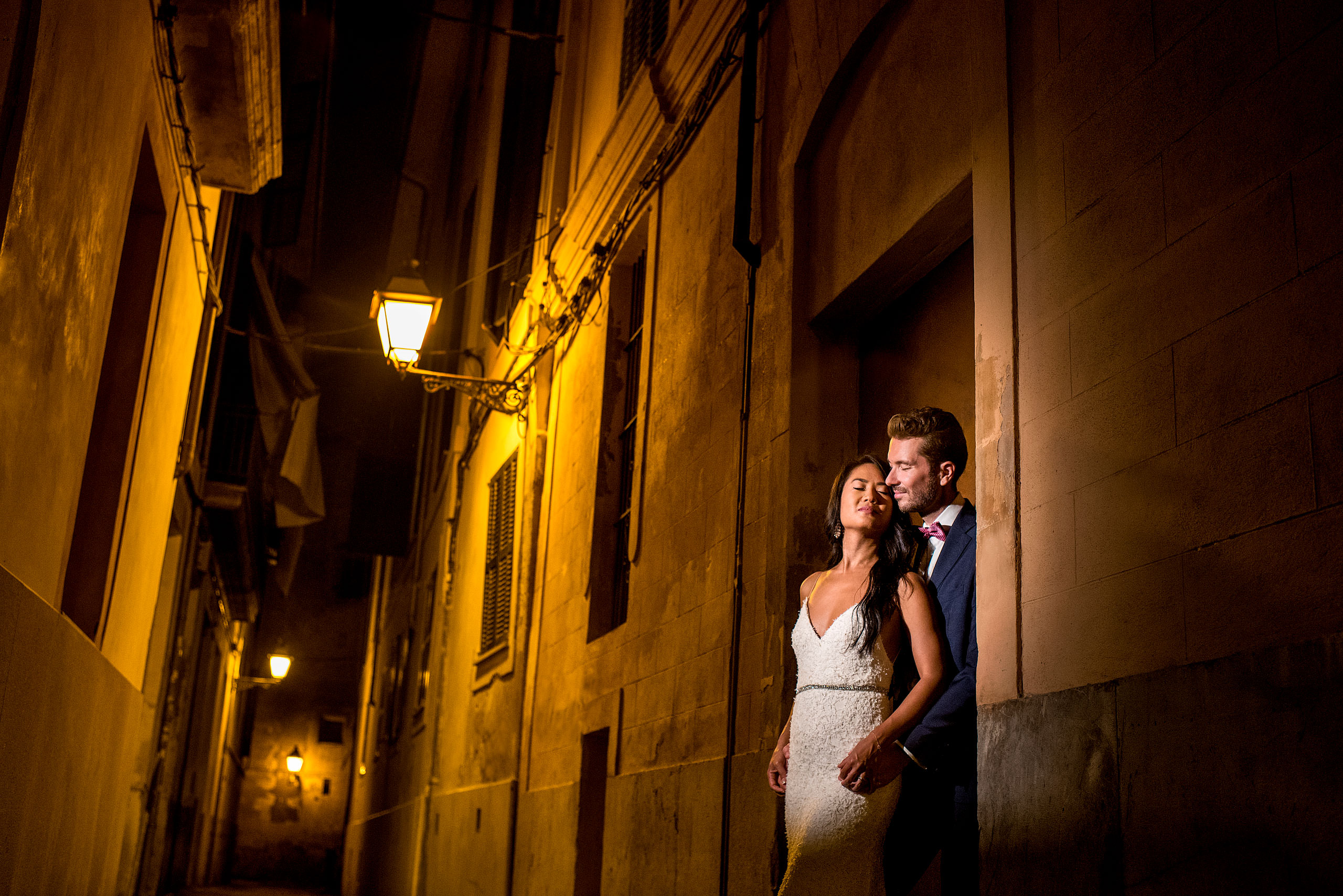 a bride and groom in the alley of Palma at castillo hotel son vida destination wedding by sean leblanc