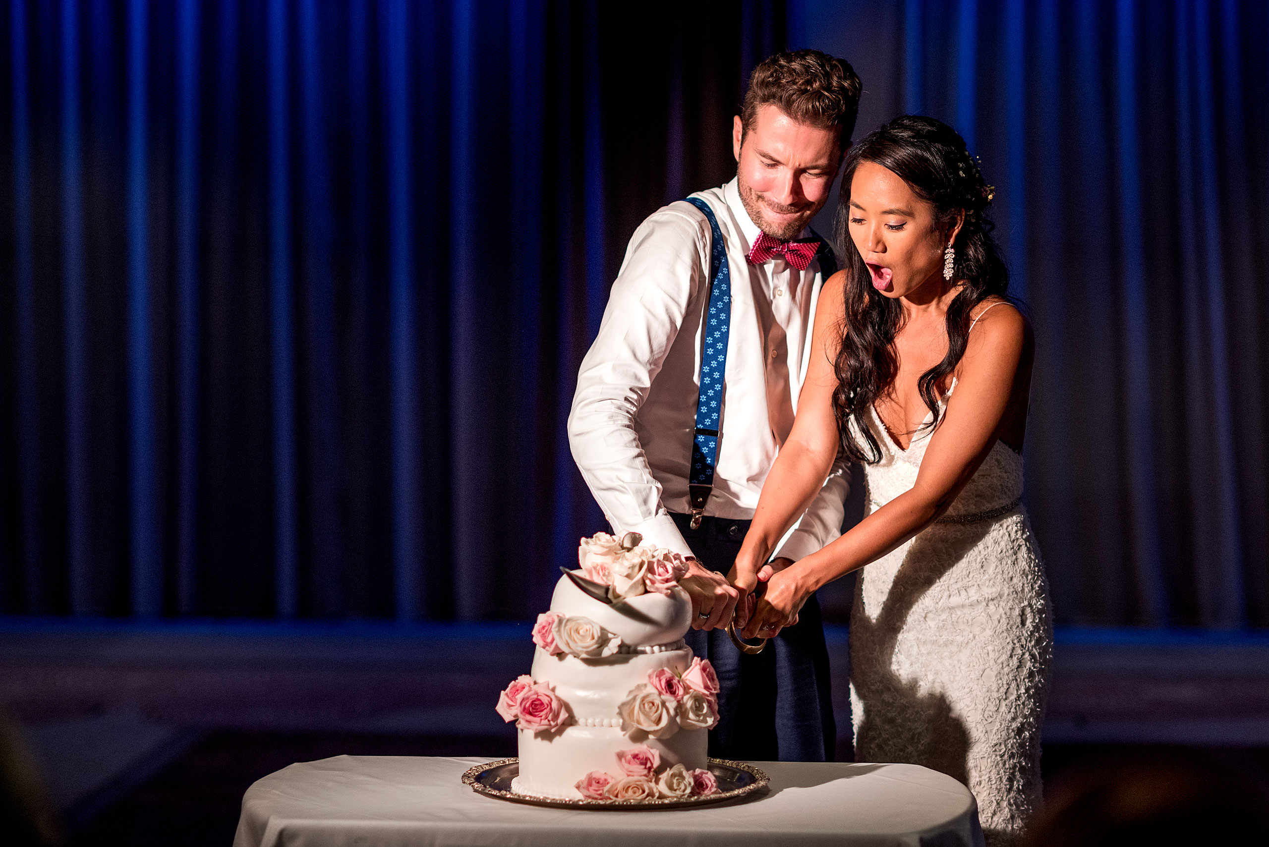 bride and groom cutting their cake with a sword at castillo hotel son vida destination wedding by sean leblanc