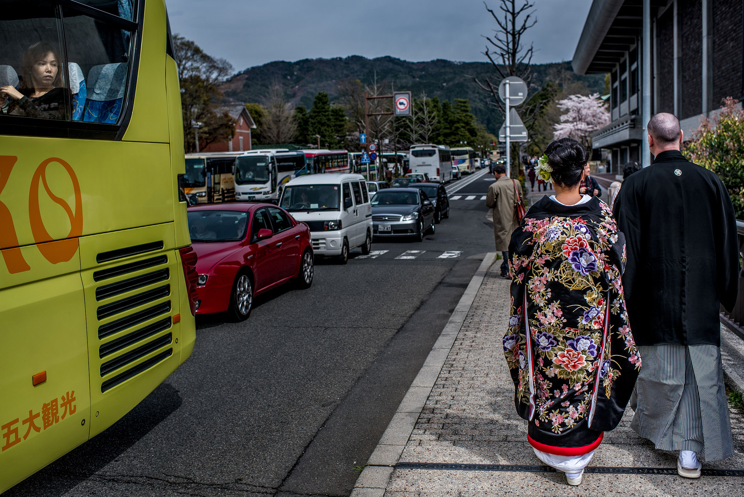 a Japanese bride and groom walking down the street by Japan Destination Wedding Photographer Sean LeBlanc